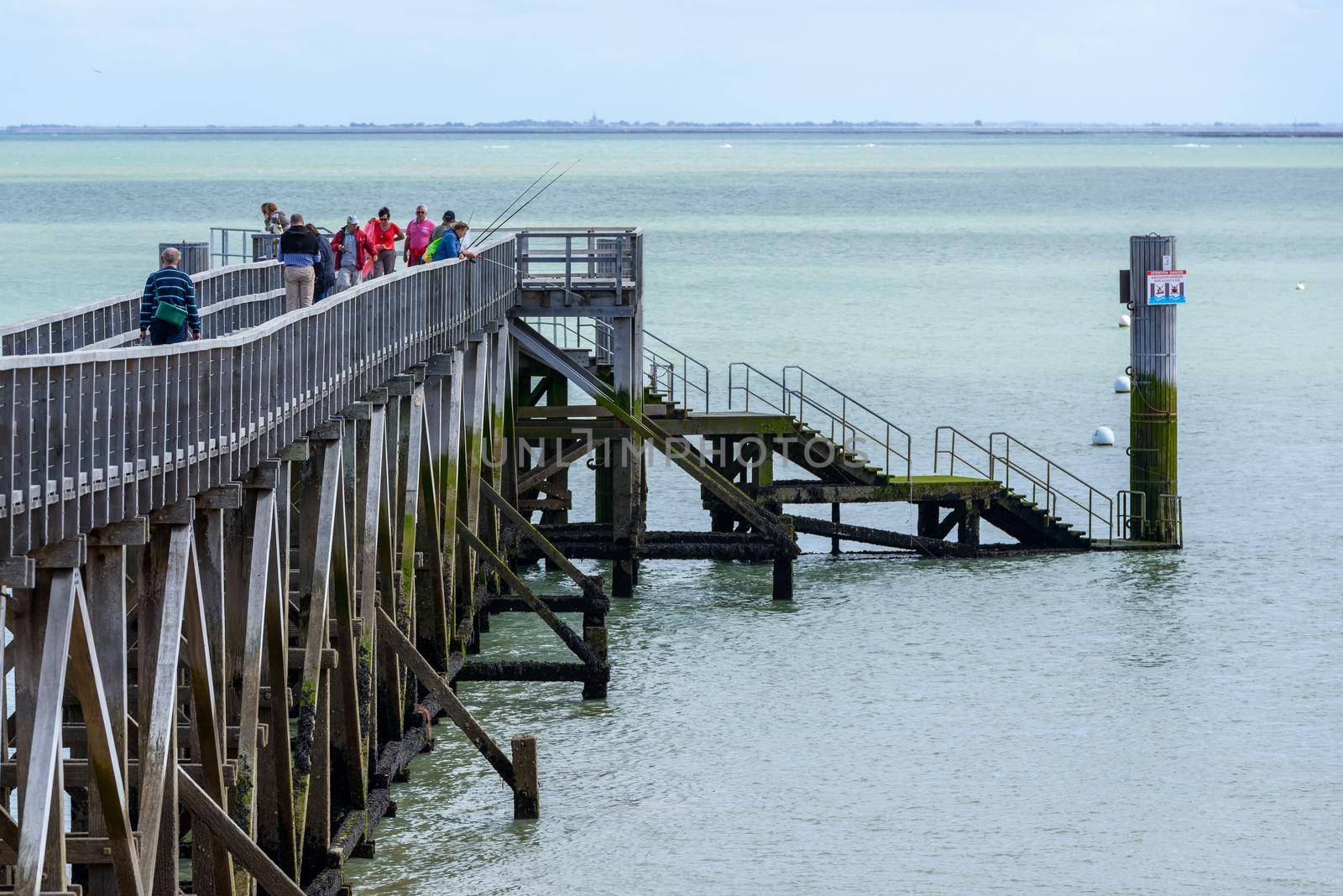 Pier on the island of Noirmoutier, France by dutourdumonde