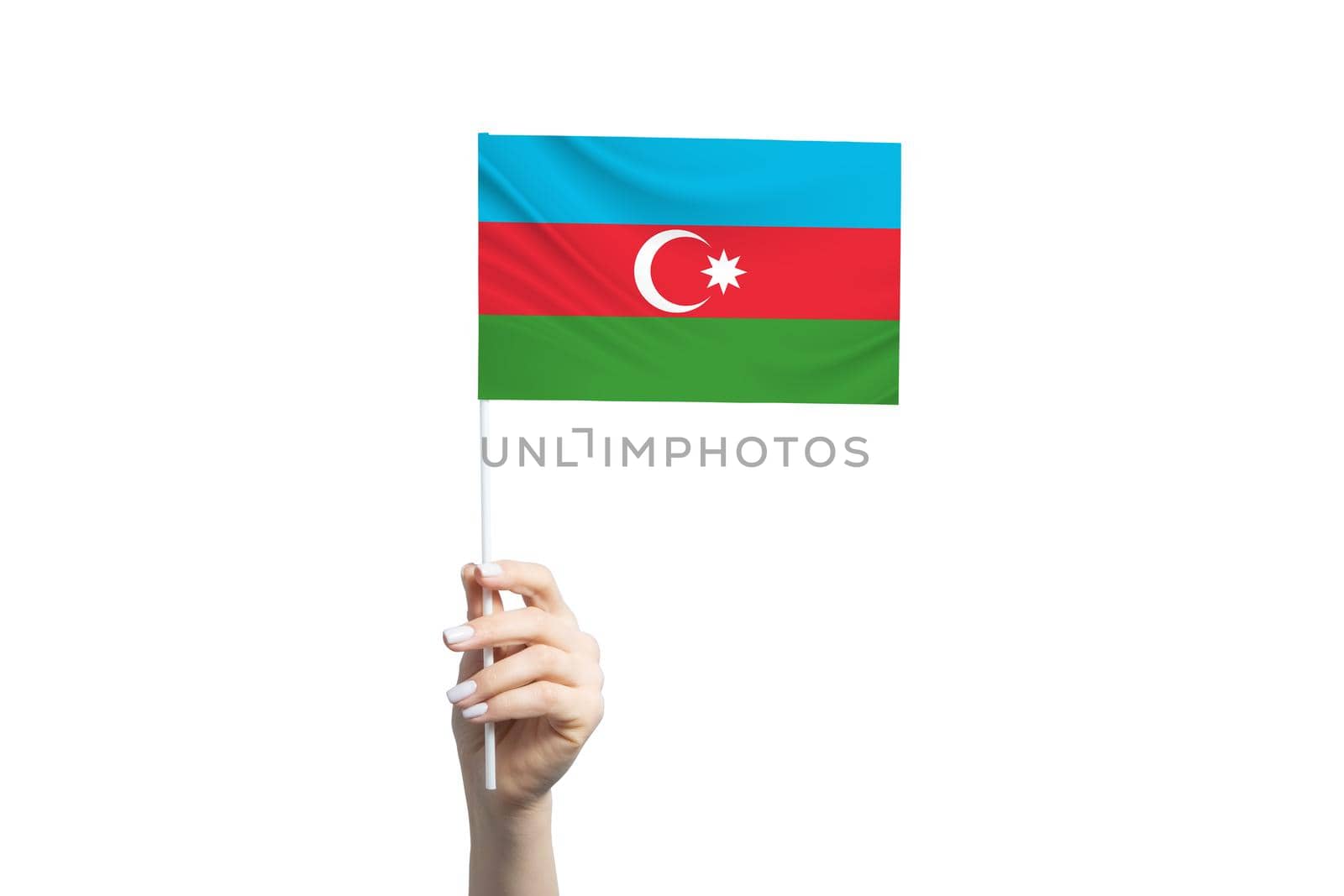 A beautiful female hand holds a Azerbaijan flag to which she shows the finger of her other hand, isolated on white background.