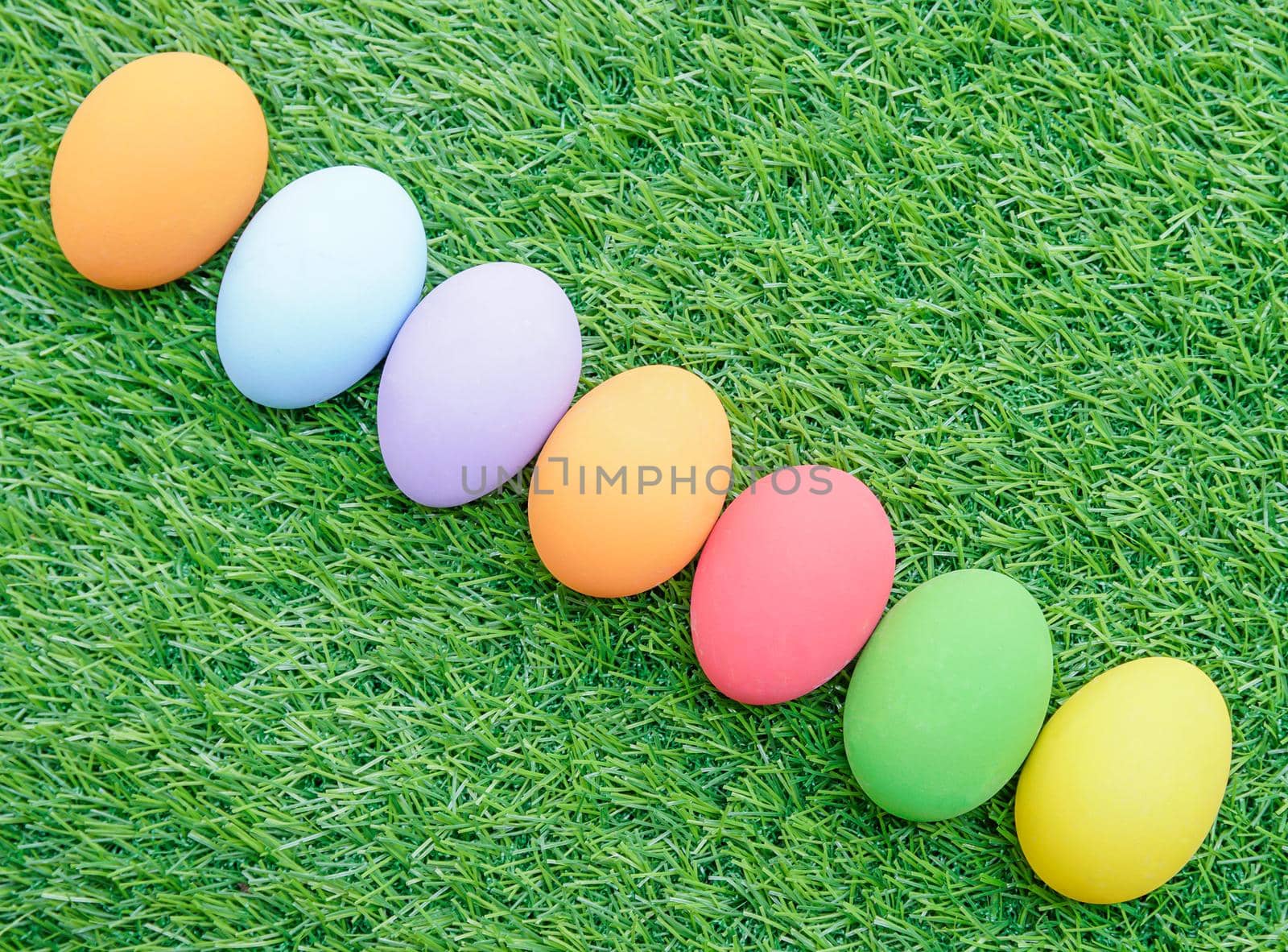 Easter eggs on green grass by stoonn