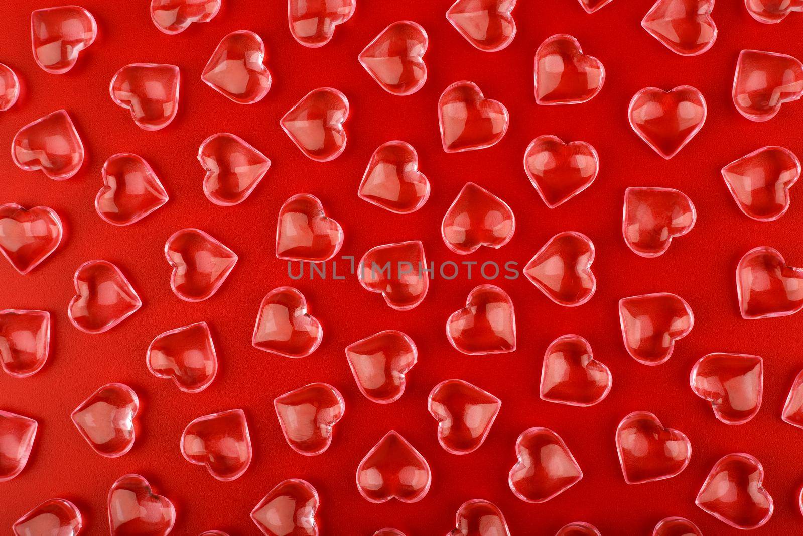  Top view of transparent glossy glass hearts. Minimalistic background template for love or St. Valentine's day concept. 