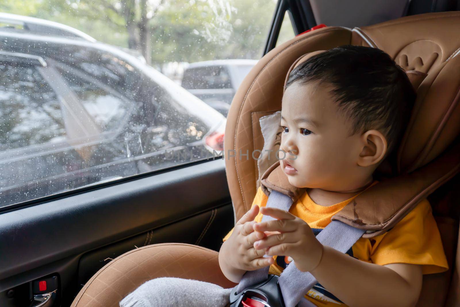 Close-up of little boy children on a car seat in the car. by chiawth
