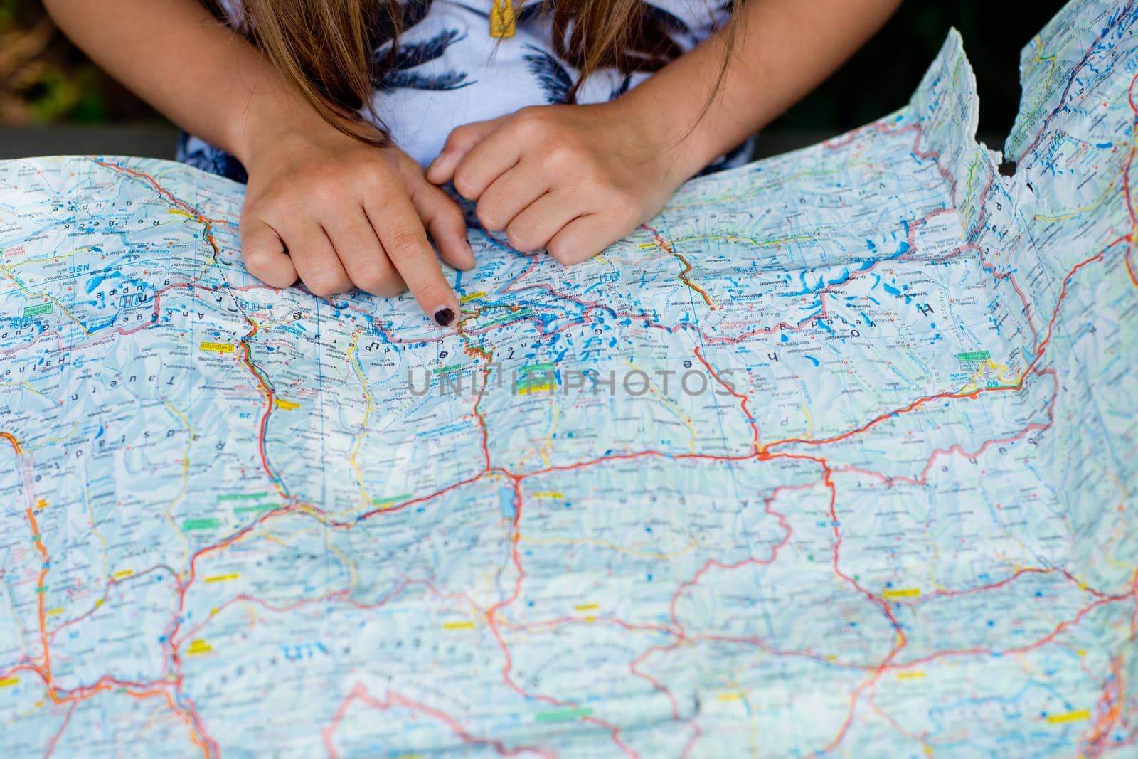 The girl is looking at the map. Close-up.