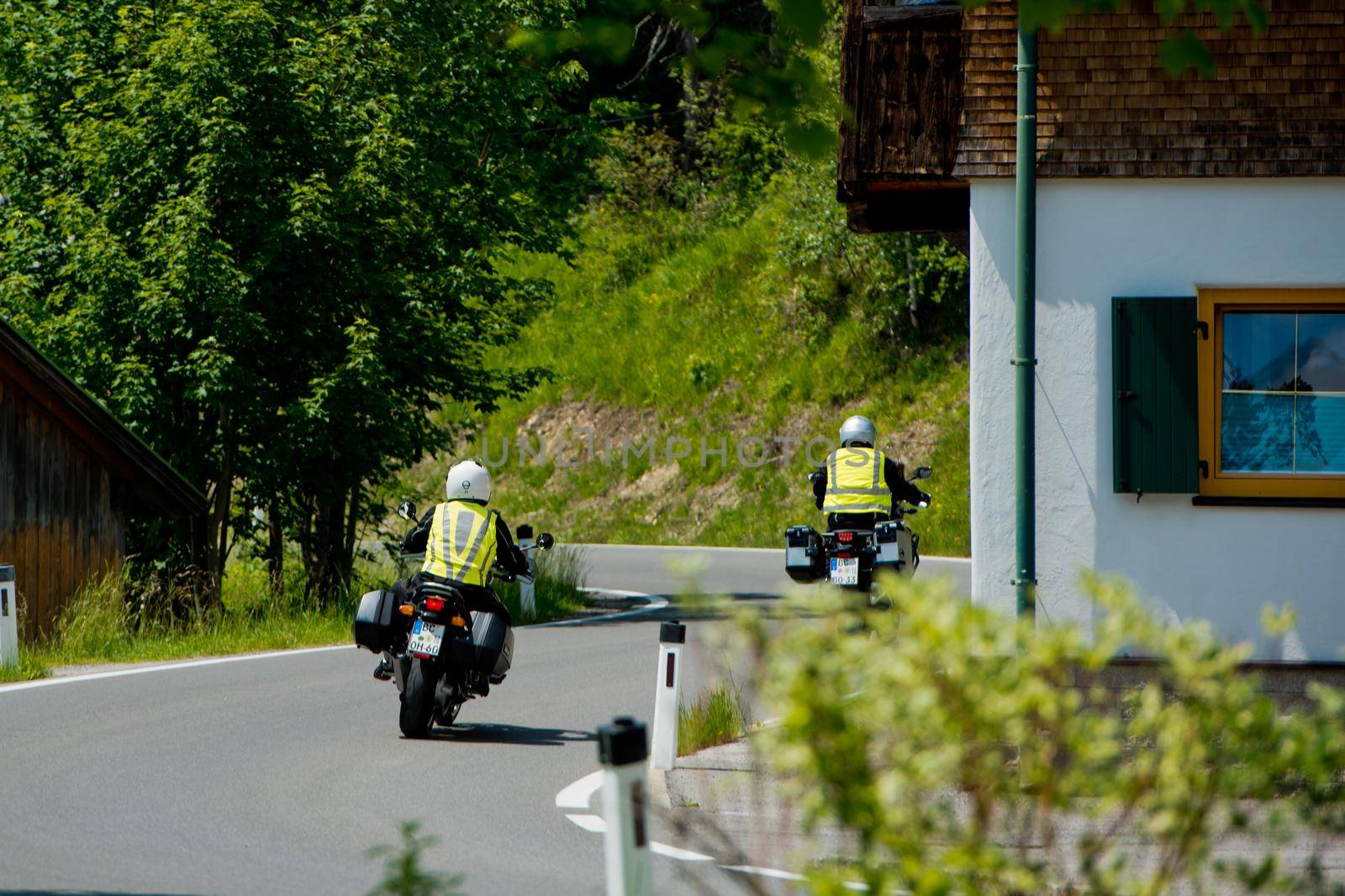 Plansee lake, Austria - June 20, 2017: Motorcyclists are driving along the road along the lake.