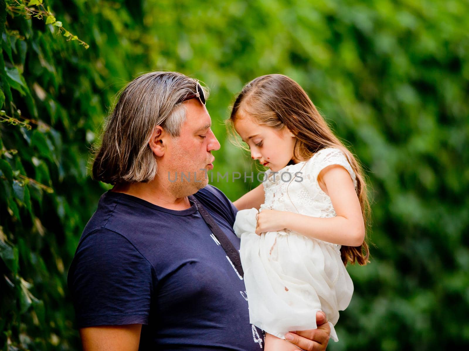 The father holds his little daughter in his arms. Father's Day. by leonik