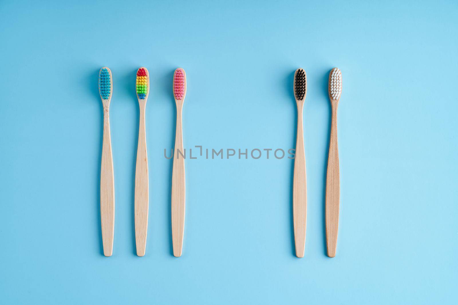 A bunch of eco-friendly bamboo toothbrushes. Global environmental trends. Gender and racial inequality. toothbrushes of different genders.