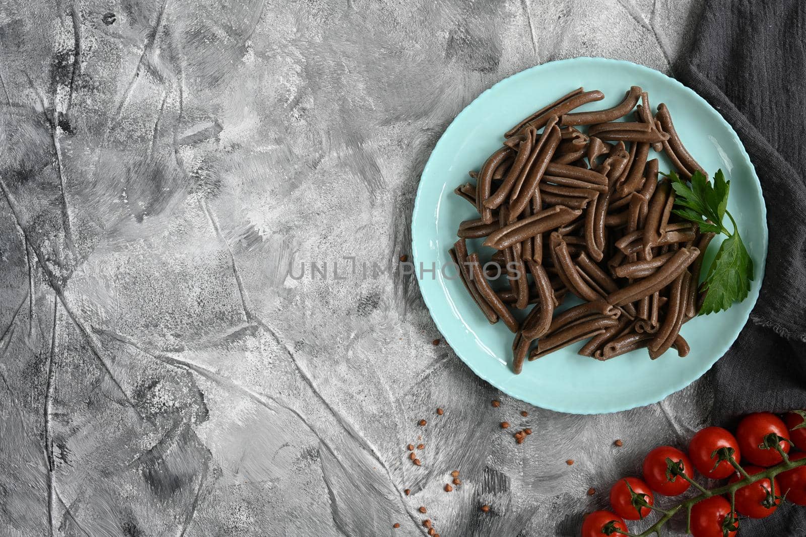 buckwheat spaghetti. Buckwheat pasta on a light grey table. Asian soba