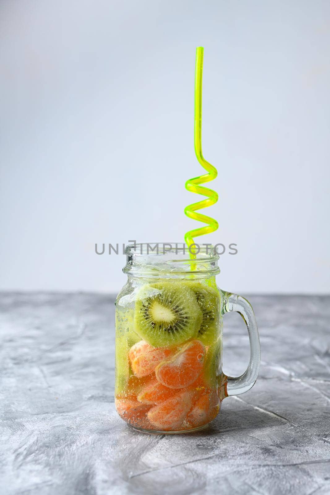 lemonade with citrus and kiwis on gray backgrounds by sashokddt