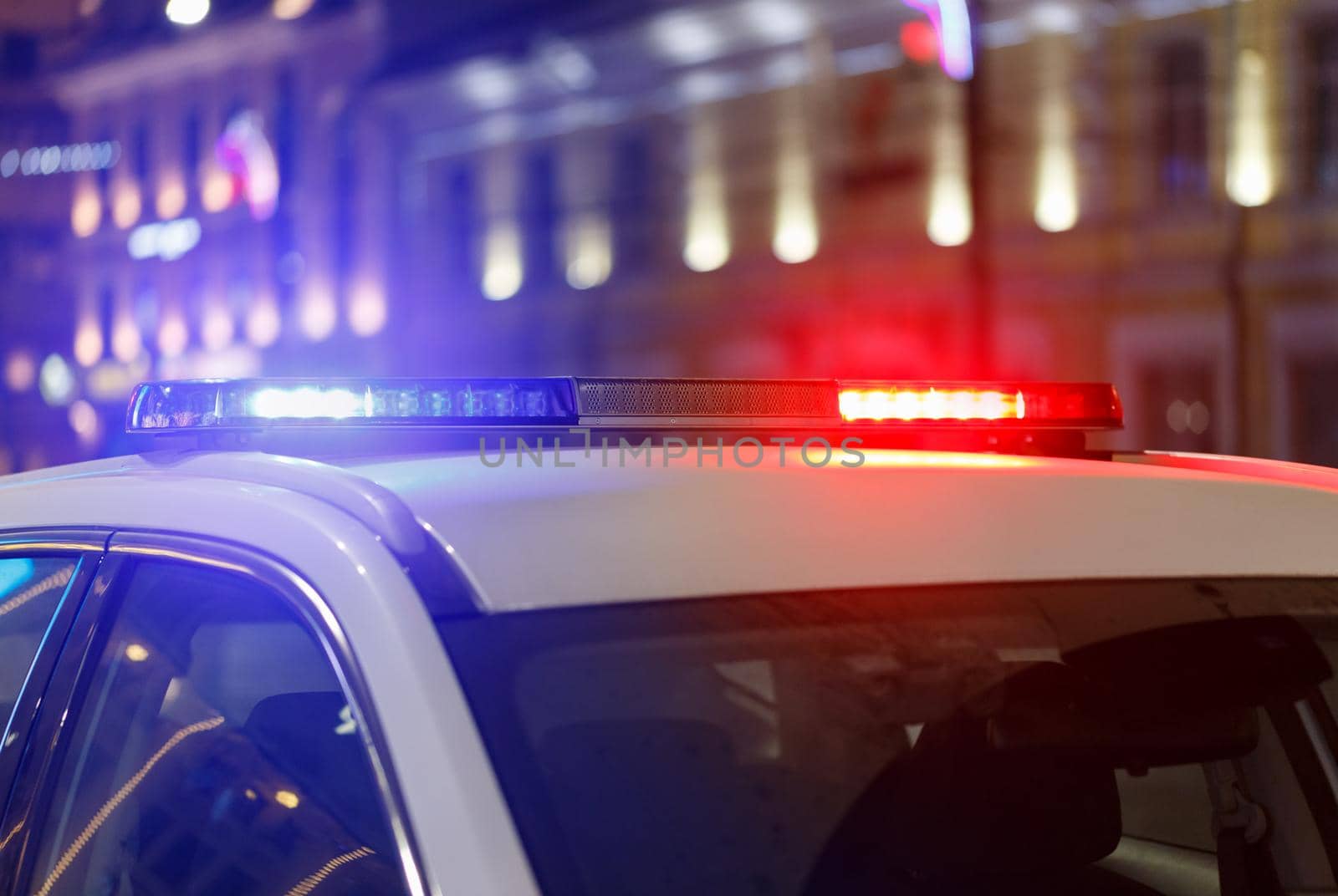 abstract night police car lights in city with selective focus and bokeh blur