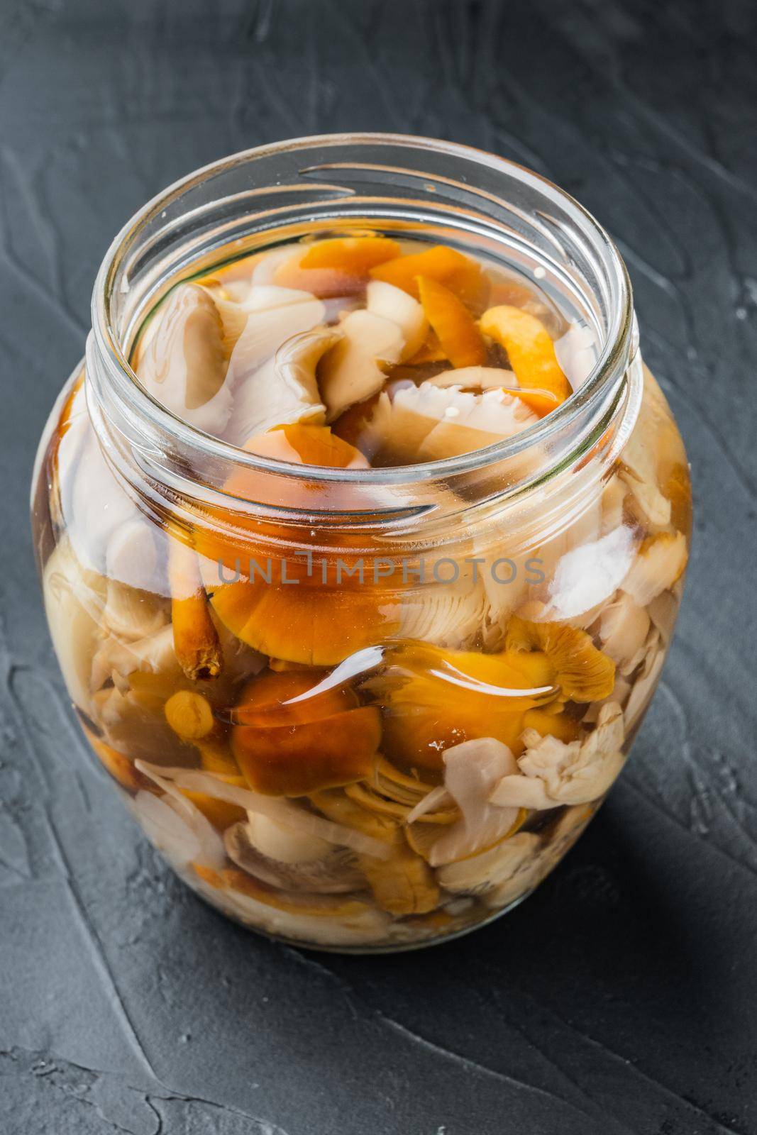 Canned mushrooms in oil set, on black background