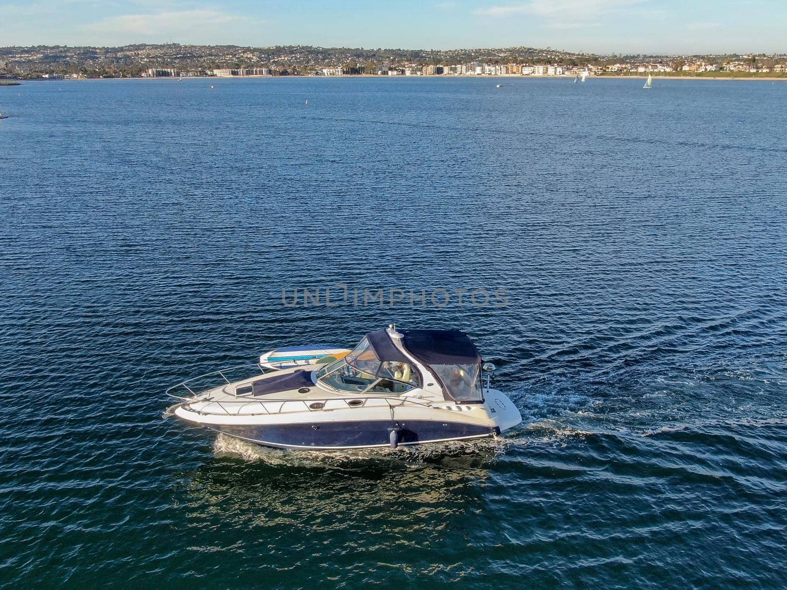 Aerial view of small speed boat in the Mission Bay of San Diego, California, USA. Small power boat yachts cruising on a calm water in the bay. March 22nd, 2020