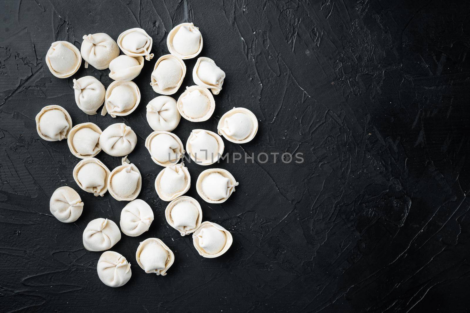 Frozen tortellini set, on black background, top view flat lay , with copyspace and space for text