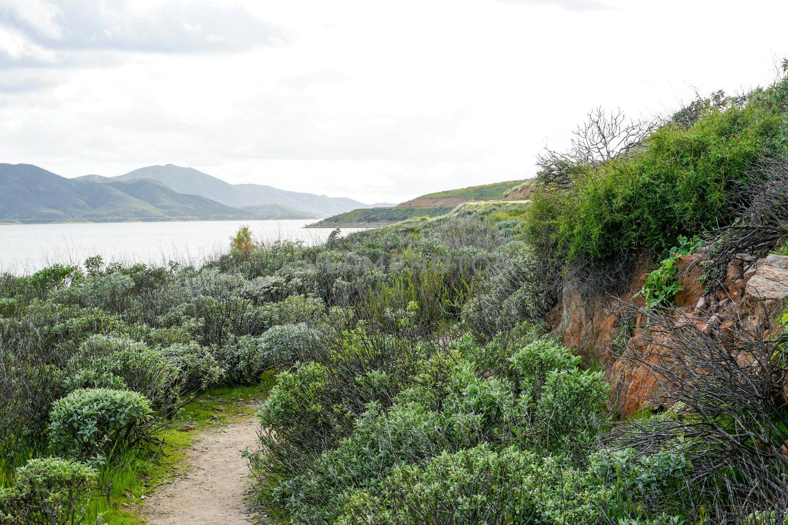 Little trail in Diamond Valley Lake during cloud day. South California by Bonandbon