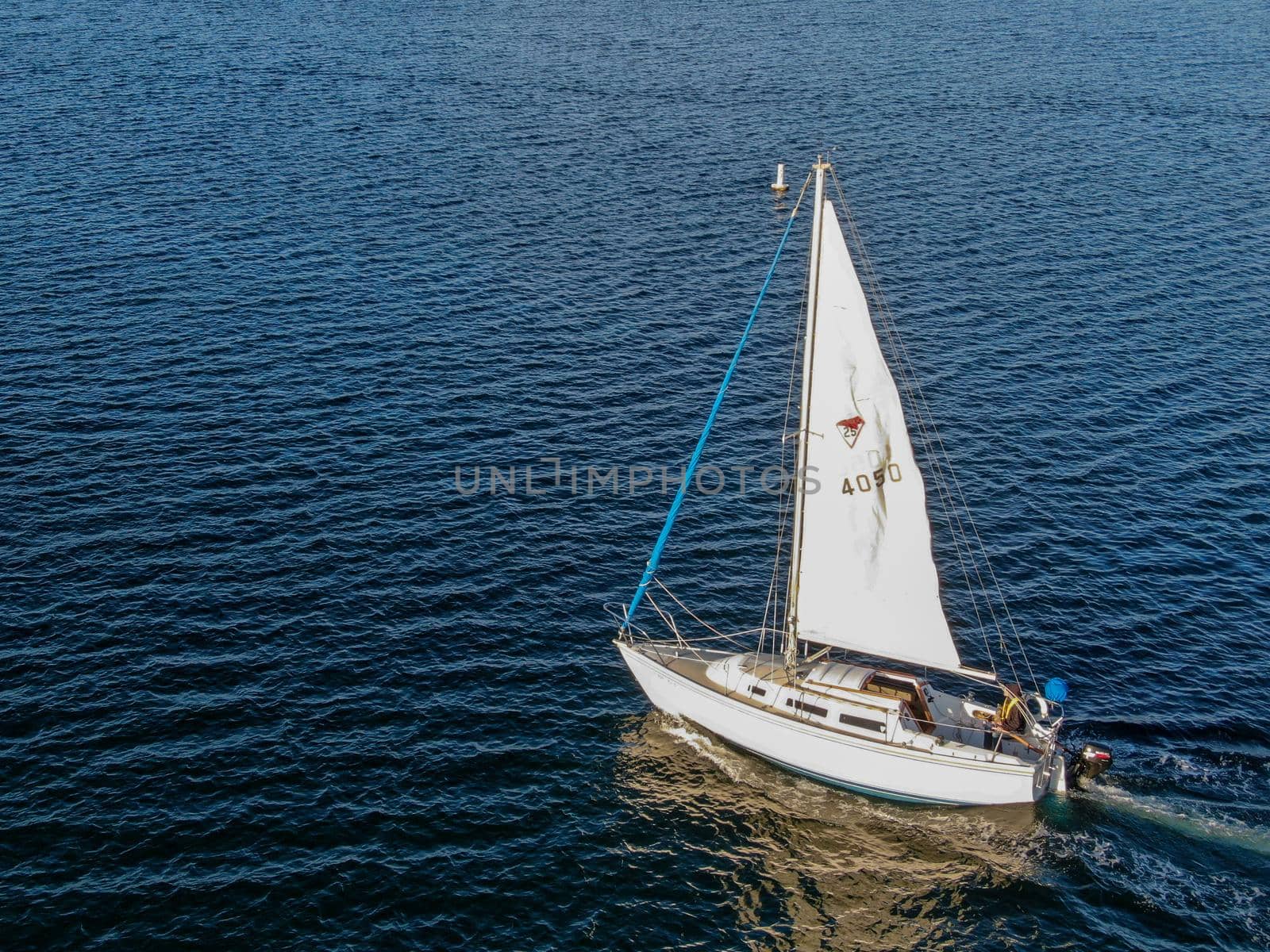 Aerial view of small sail boats in the Mission Bay of San Diego, California, USA. Small sailing ship yachts anchored in the bay. March 22nd, 2020