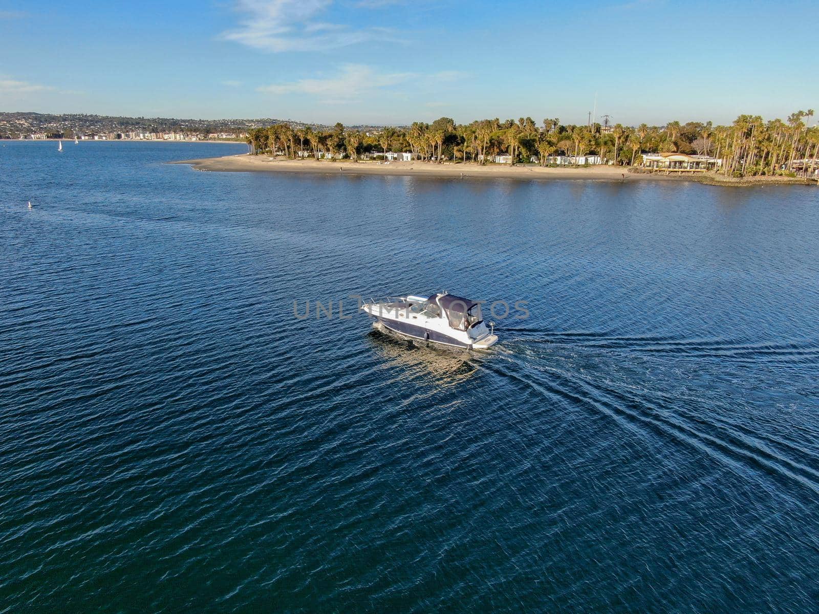 Aerial view of small speed boat in the Mission Bay of San Diego, California, USA. Small power boat yachts cruising on a calm water in the bay. March 22nd, 2020