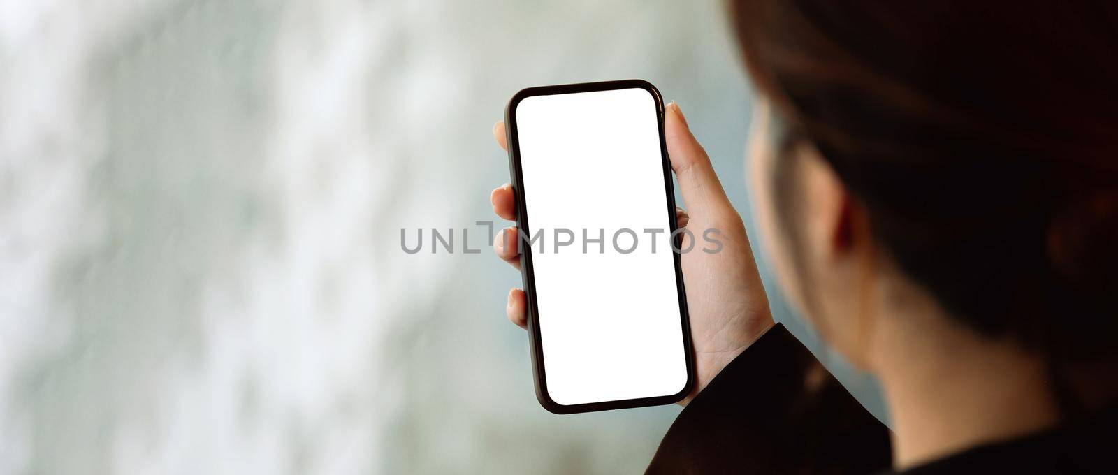 Close up view of a woman using smartphone, Blank screen mobile phone for graphic display montage
