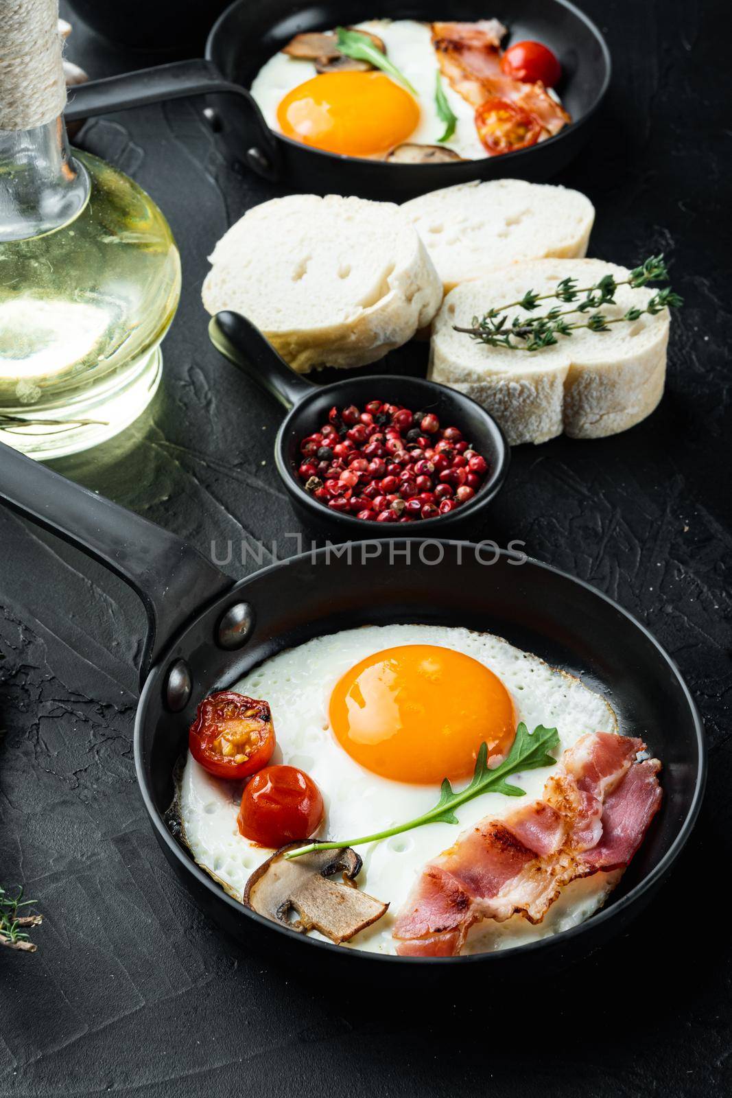 Fried Egg with ingredient in cast iron frying pan, on black background