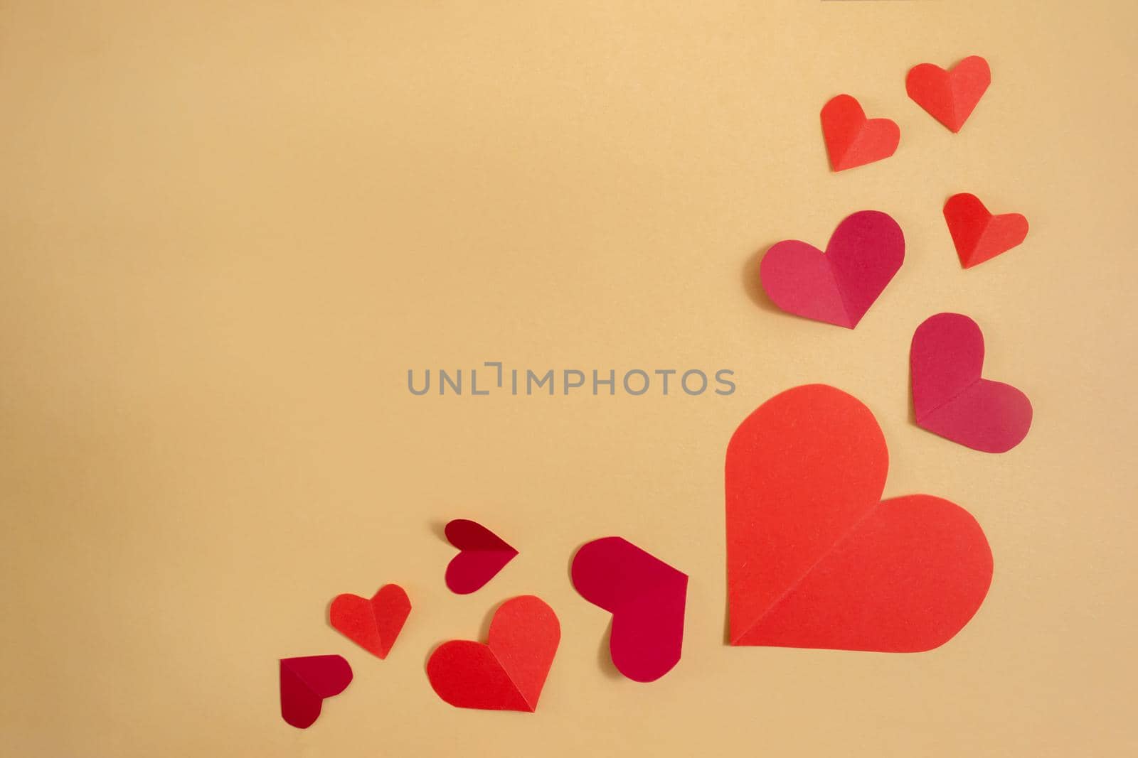 Valentine's Day background. Pink and red hearts on a pastel yellow background. Valentine's Day concept. Flat lay, top view, copy space