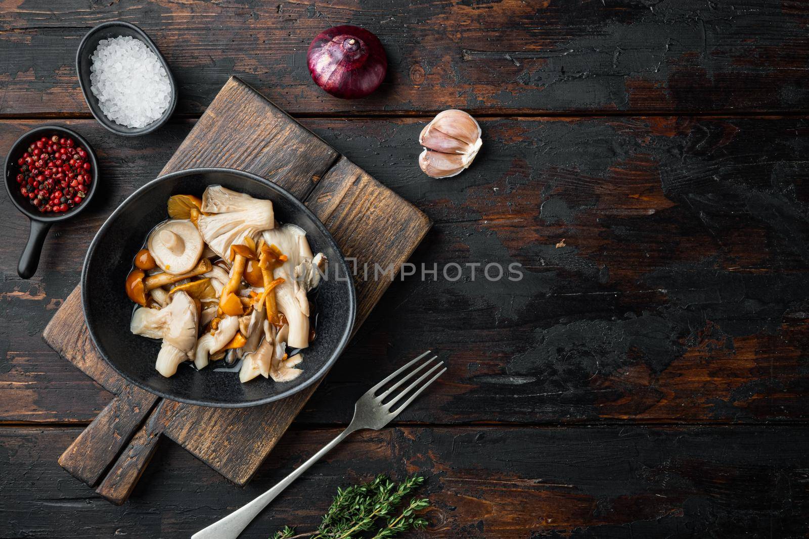 Wild mushrooms Boletus edulis and cap boletus in a jar set, on old dark wooden table background, top view flat lay , with space for text copyspace