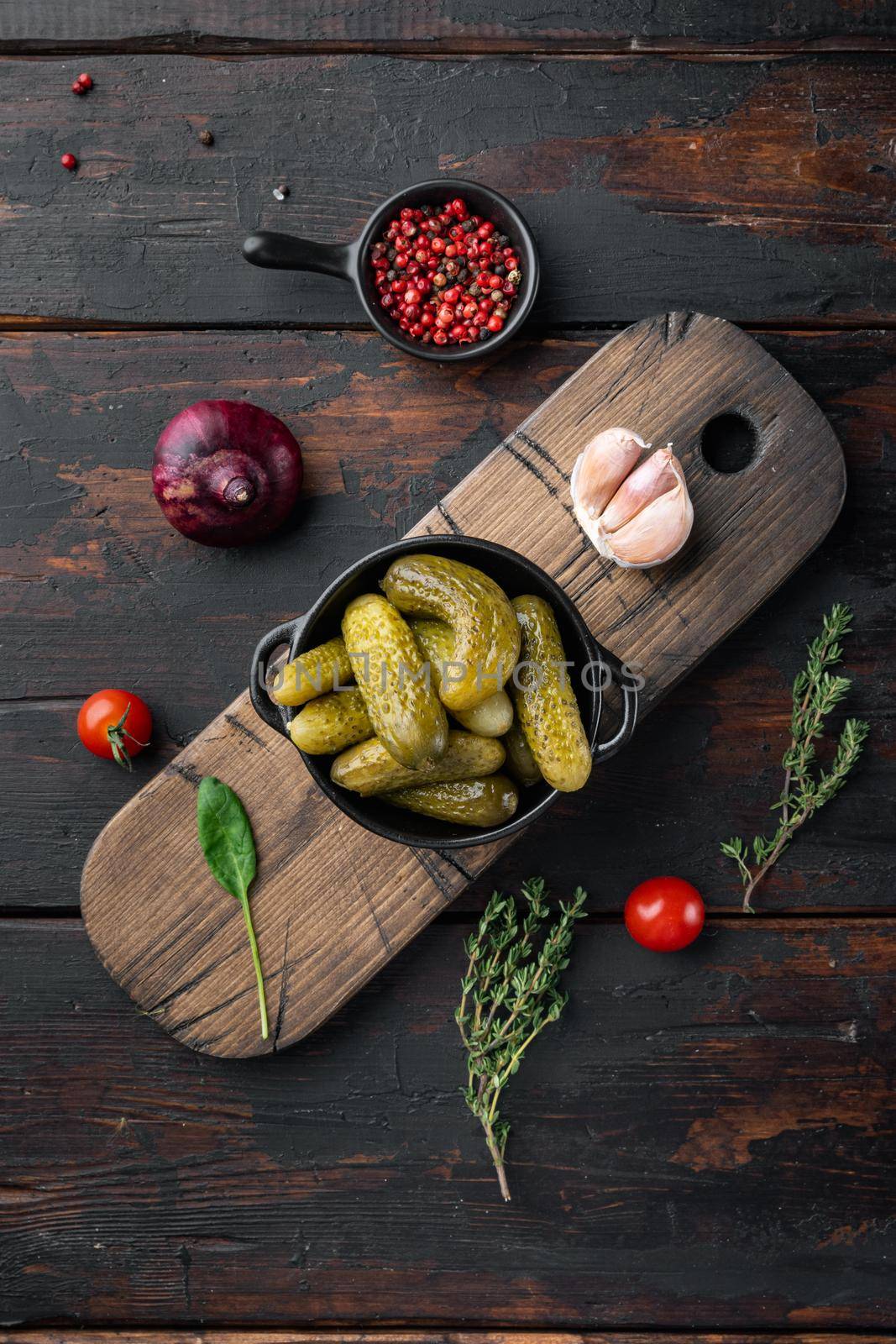 Fermented vegetables Pickled gherkins cucumbers set, on old dark wooden table background, top view flat lay