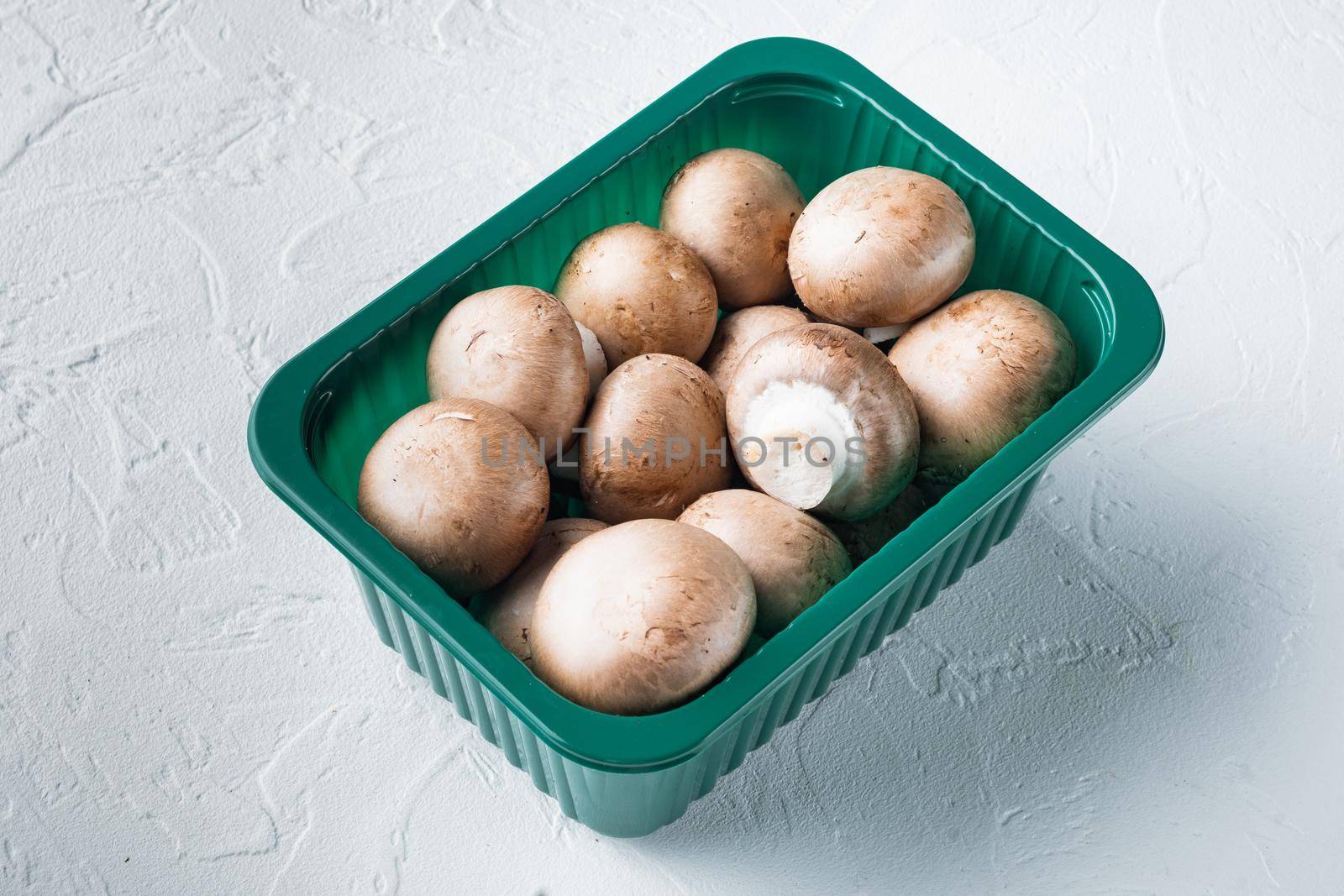 Raw mushrooms champignons set, on white background, in plastic pack