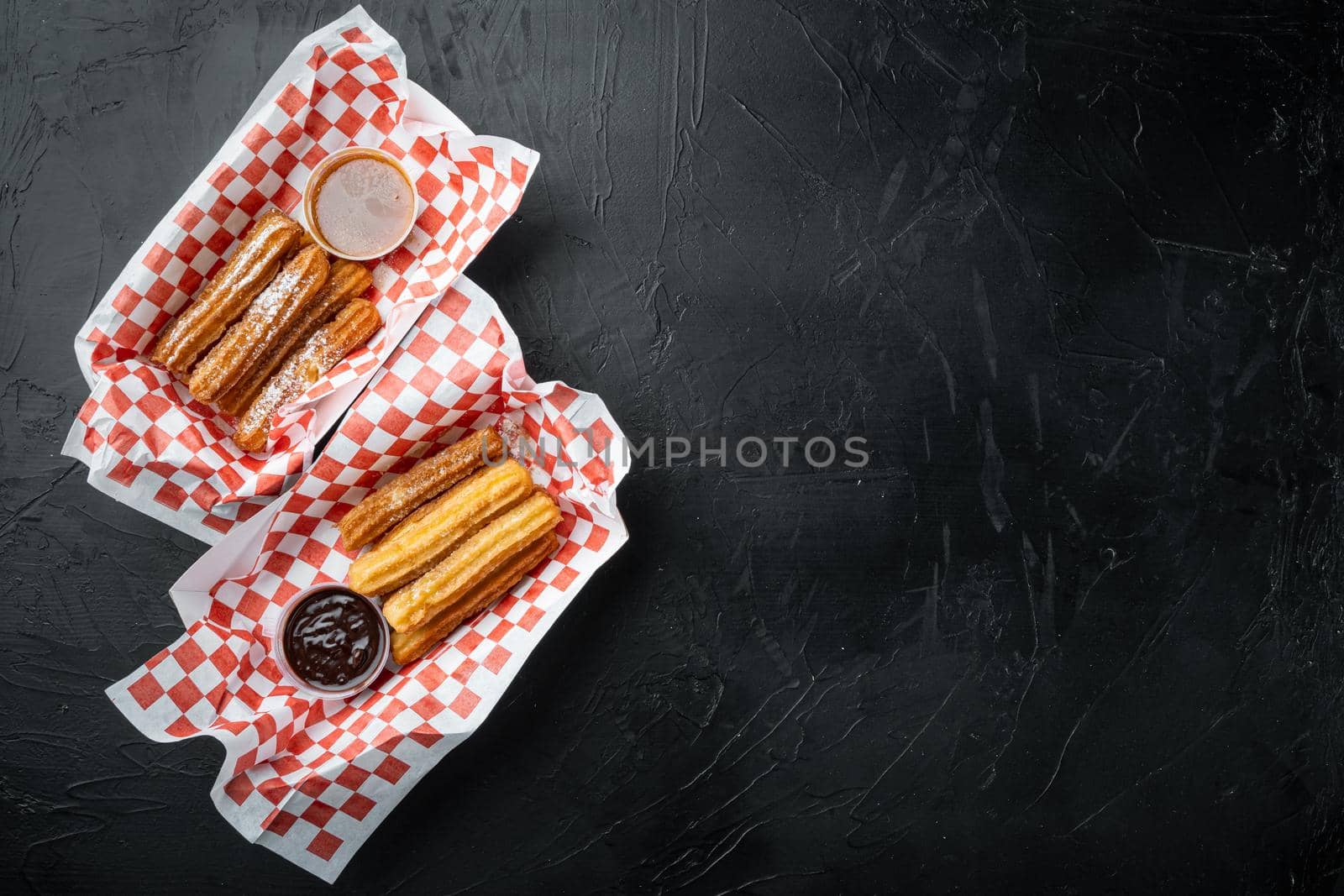 Fried Crullers in Brown, Take Away Bag in paper tray, on black background, top view flat lay with space for text, copyspace