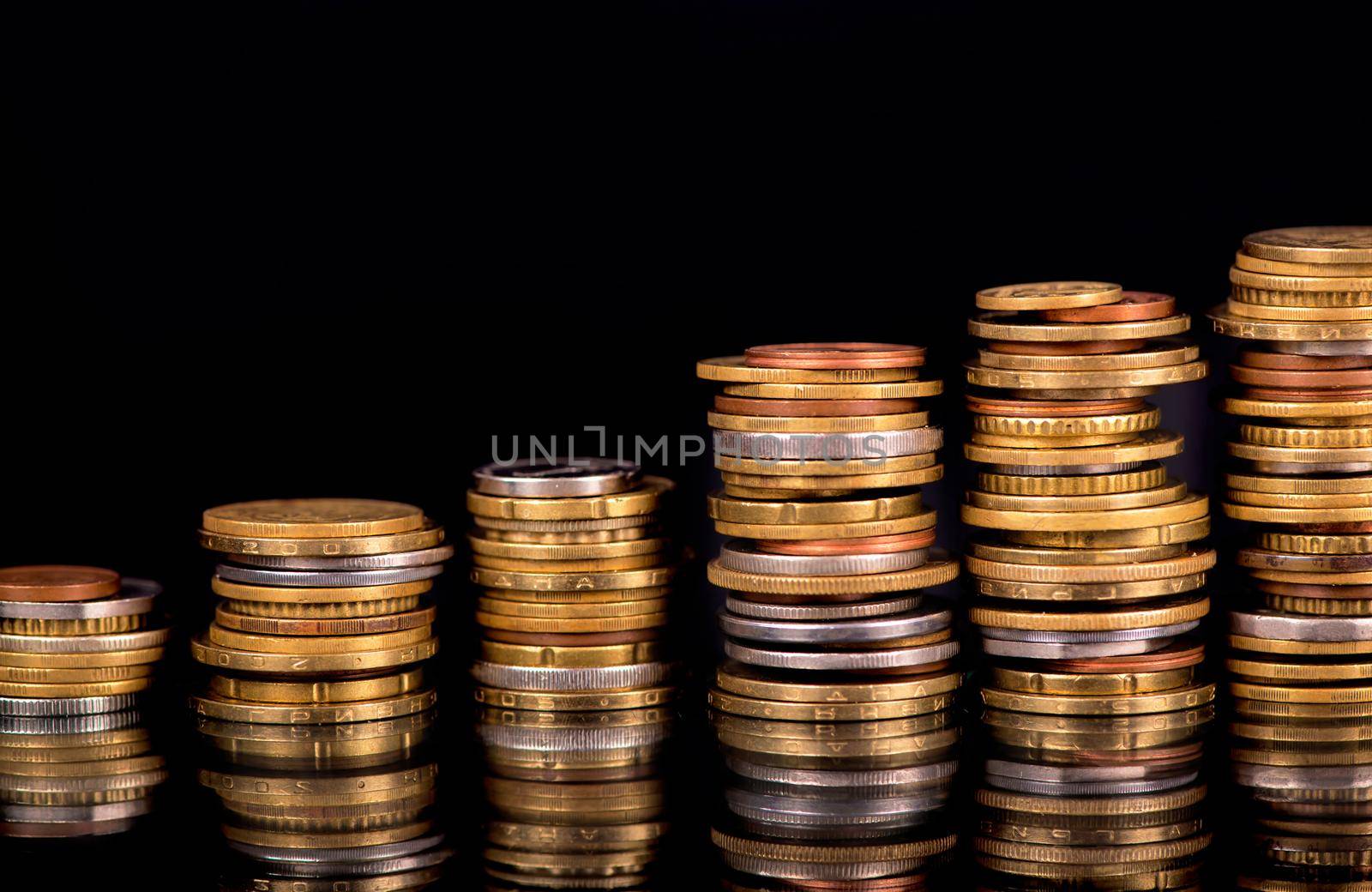 Stack Coins Over Black Background by aprilphoto