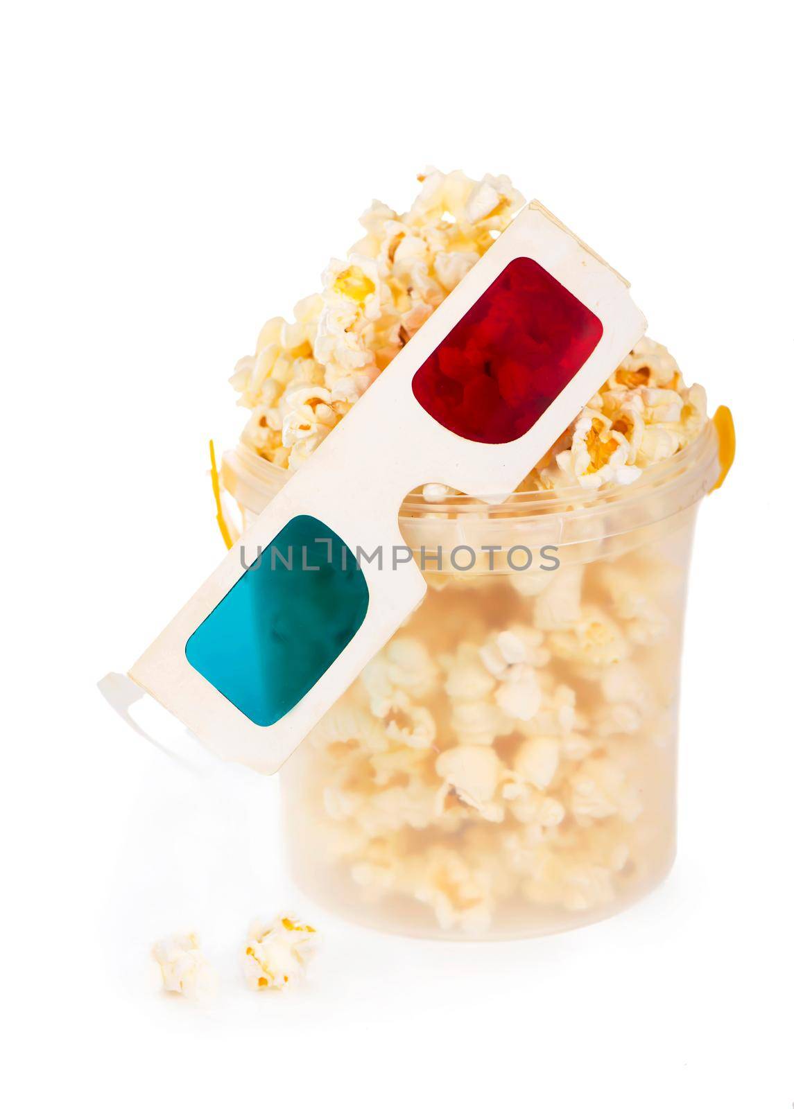 Paper striped bucket with popcorn and 3D glasses isolated on white background with clipping path. Concept of cinema or watching TV. by aprilphoto