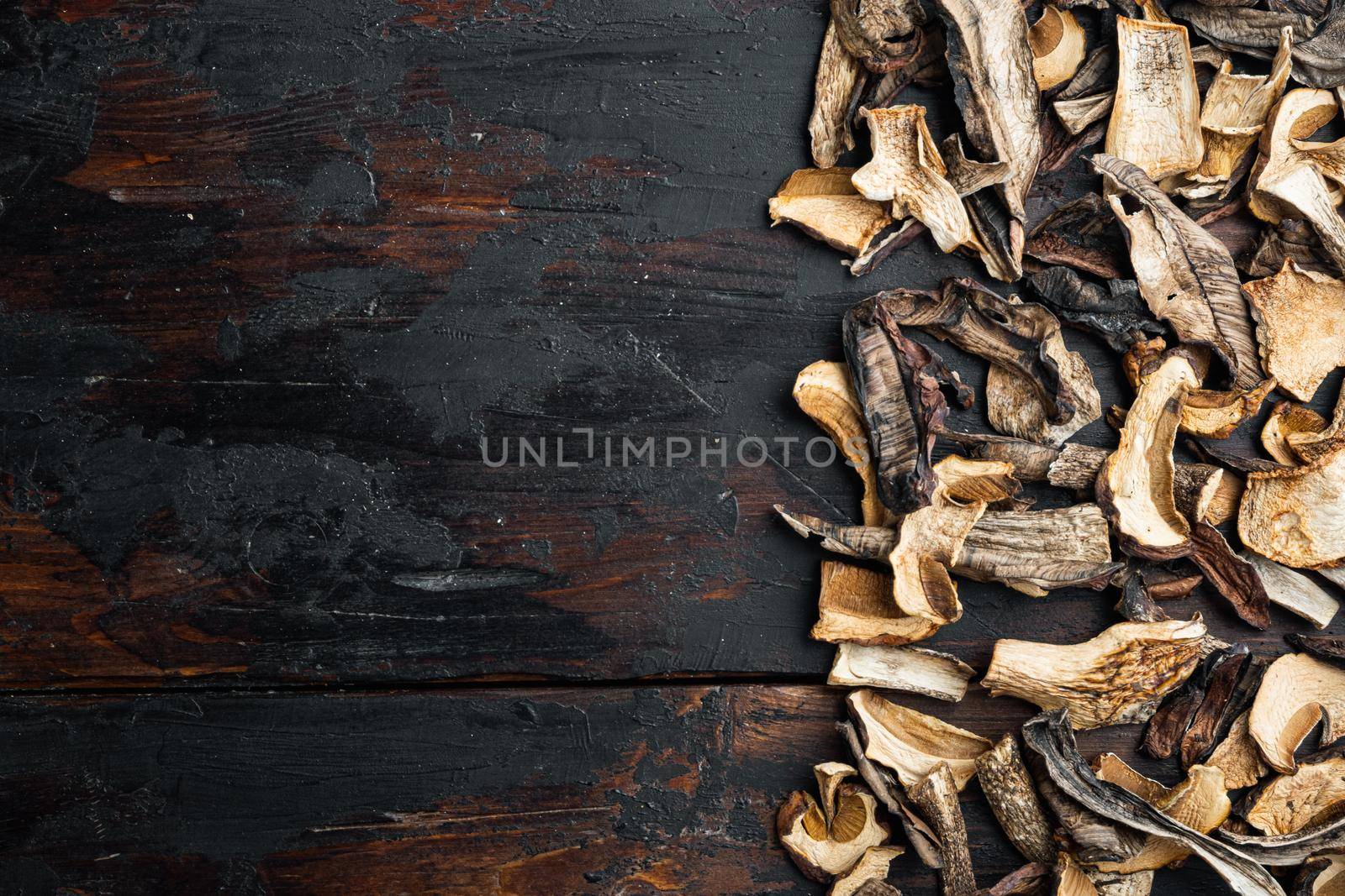 Set of dried mushrooms set, on old dark wooden table background, top view flat lay , with space for text copyspace