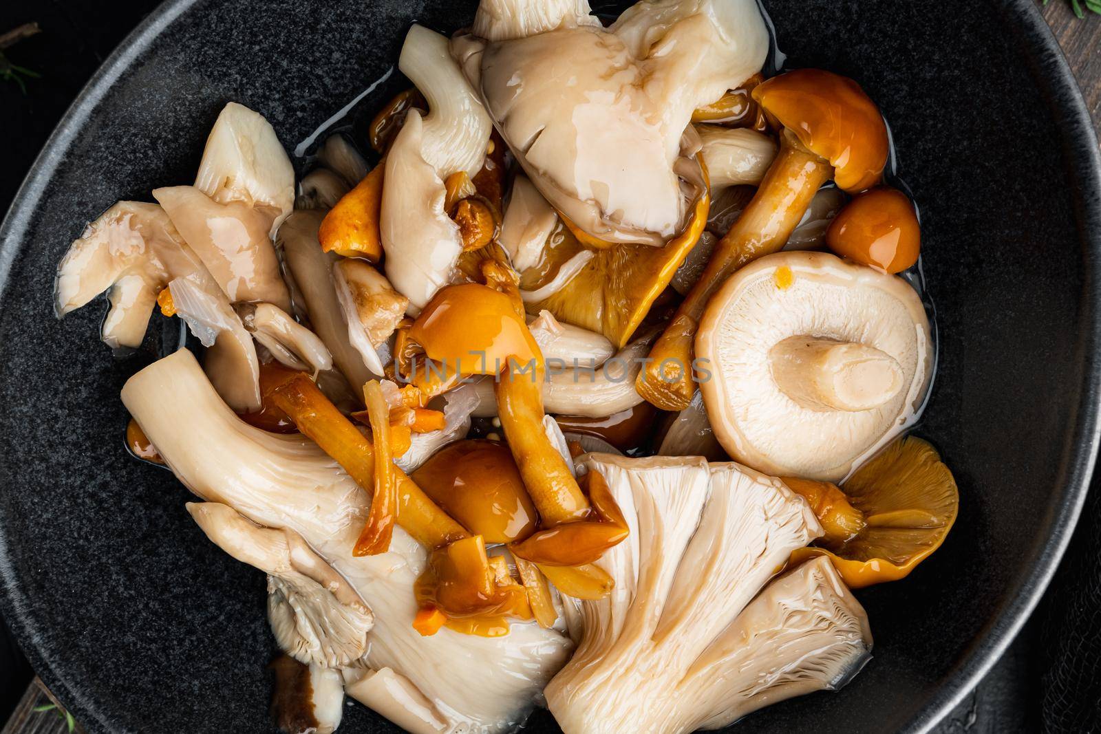Pickled mushrooms set, on black background, top view flat lay