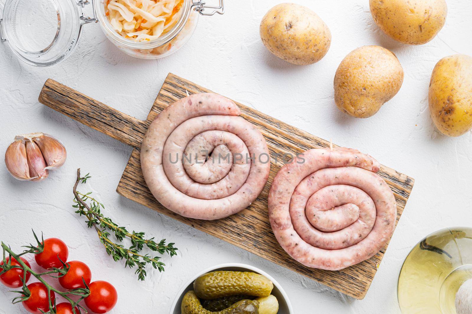 Sauerkraut with grilled sausage, on white background, top view flat lay