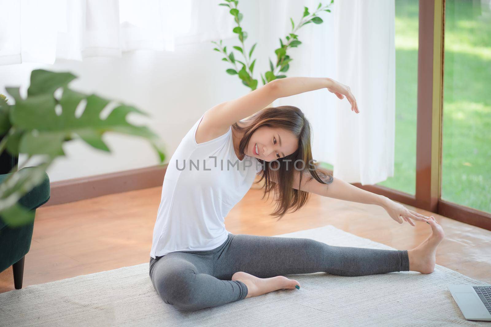 Beautiful asian woman staying fit by exercising at home for healthy trend lifestyle