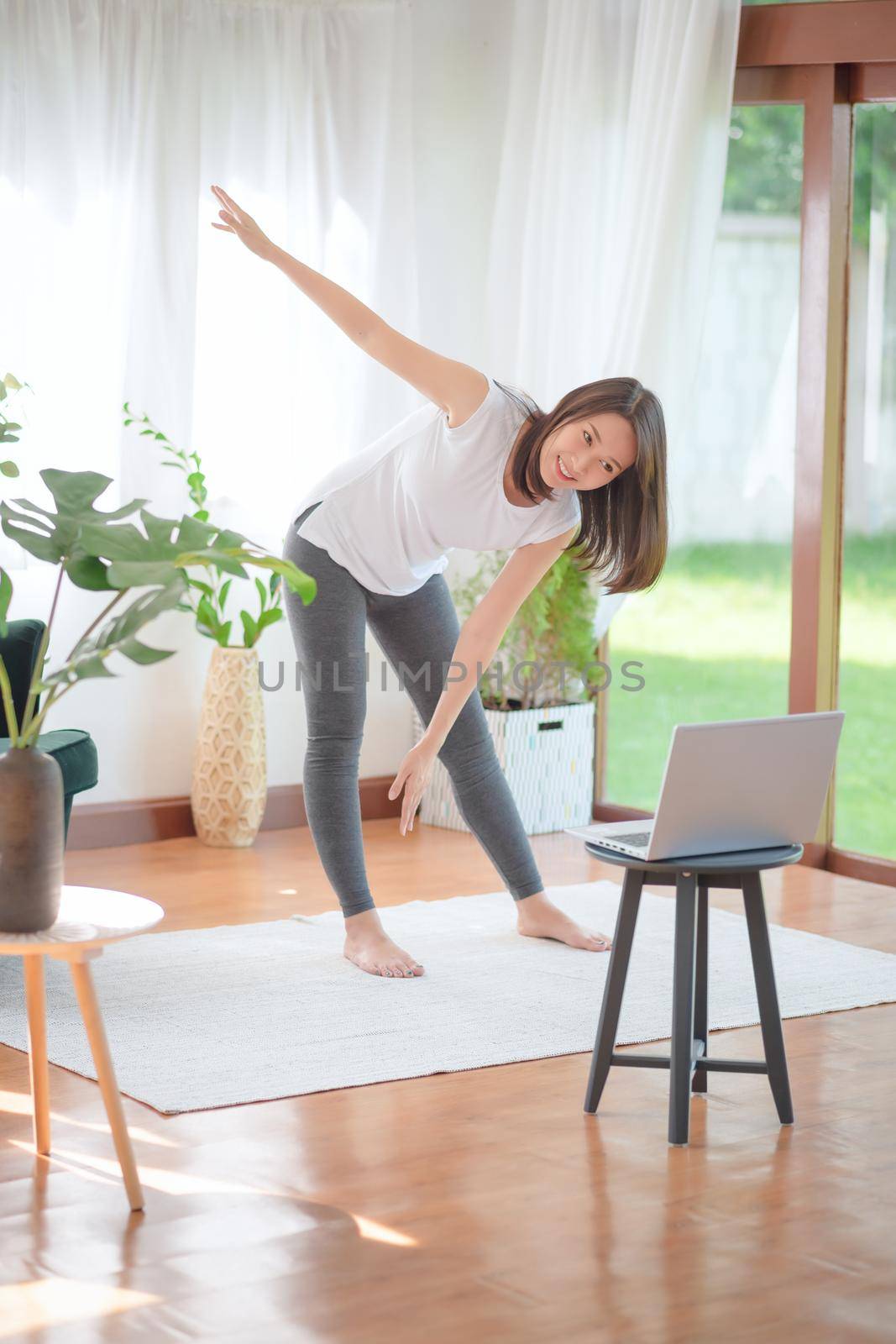 Beautiful asian woman staying fit by exercising at home for healthy trend lifestyle