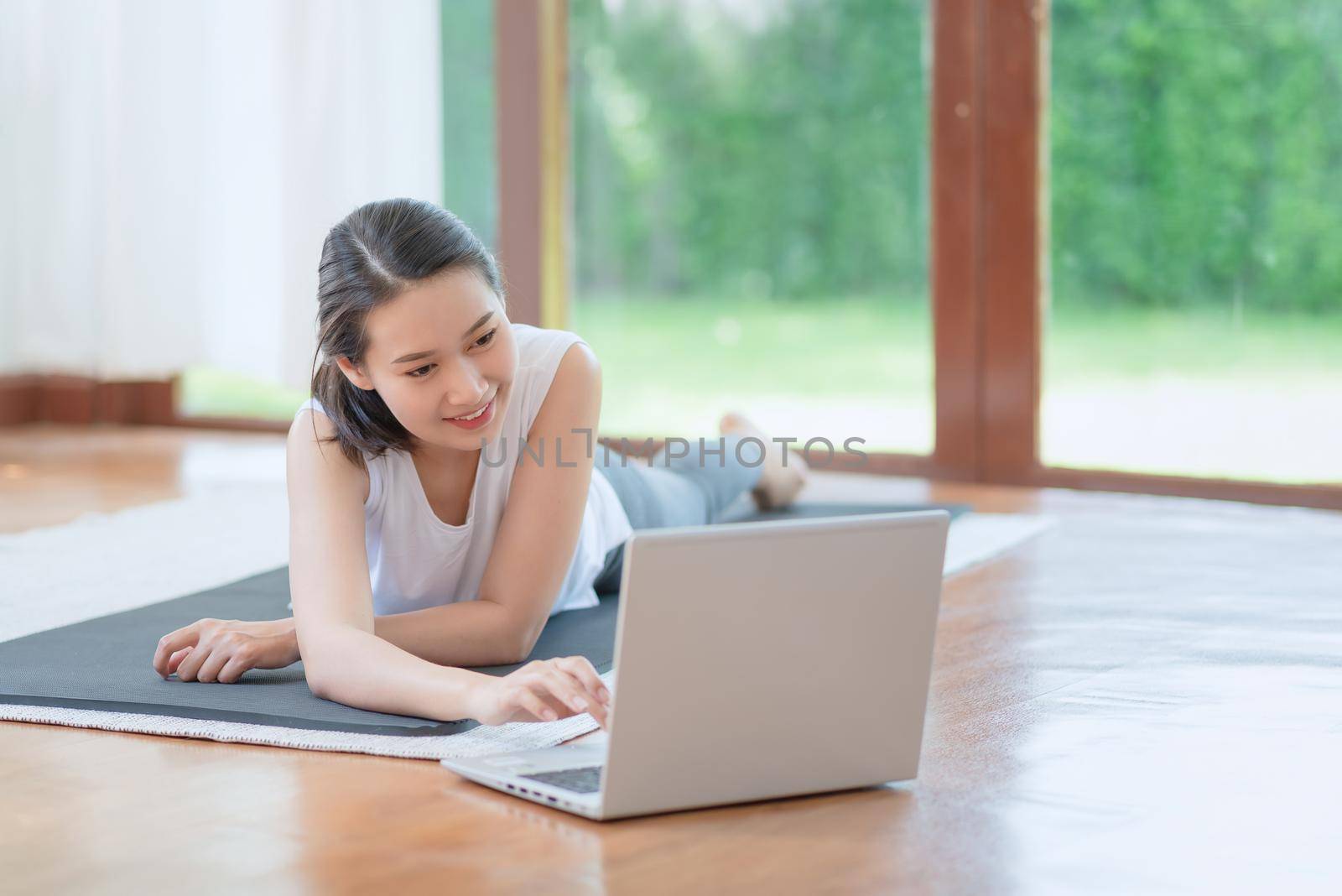 Beautiful asian woman staying fit by exercising at home for healthy trend lifestyle