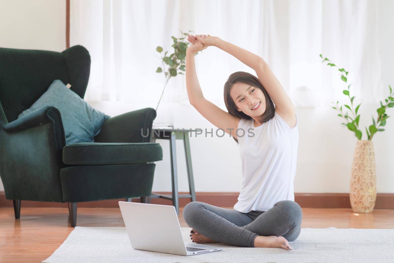 Beautiful asian woman staying fit by exercising at home for healthy trend lifestyle by Nuamfolio