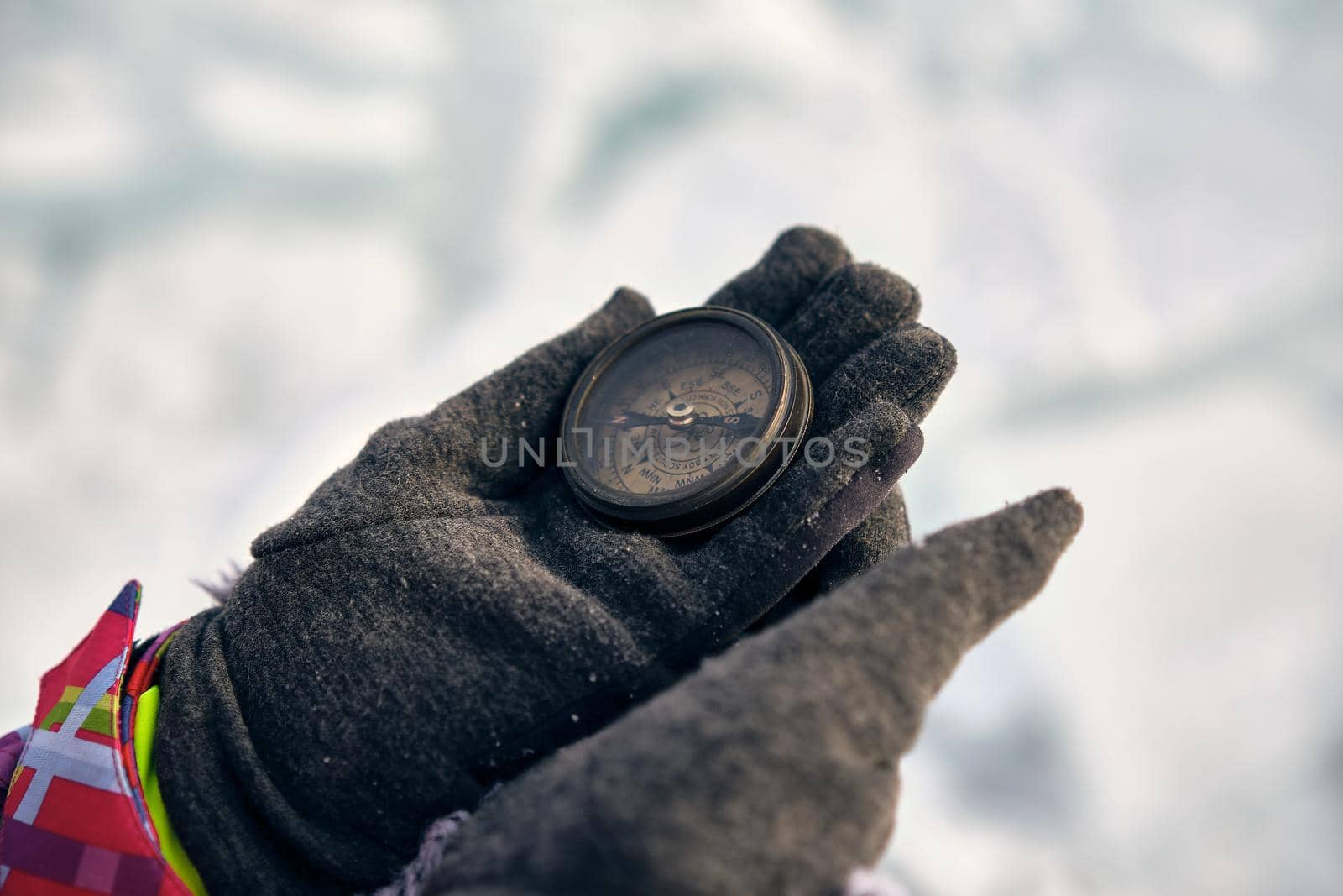 Hiker Hand Holding A Compass And Ices In Background