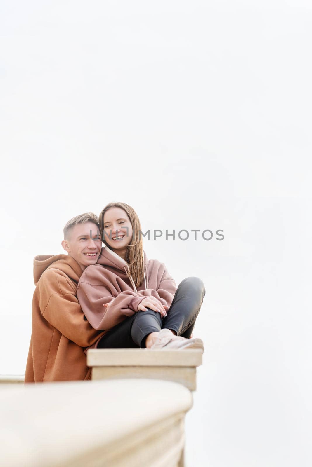 Young loving couple embracing each other outdoors in the park by Desperada