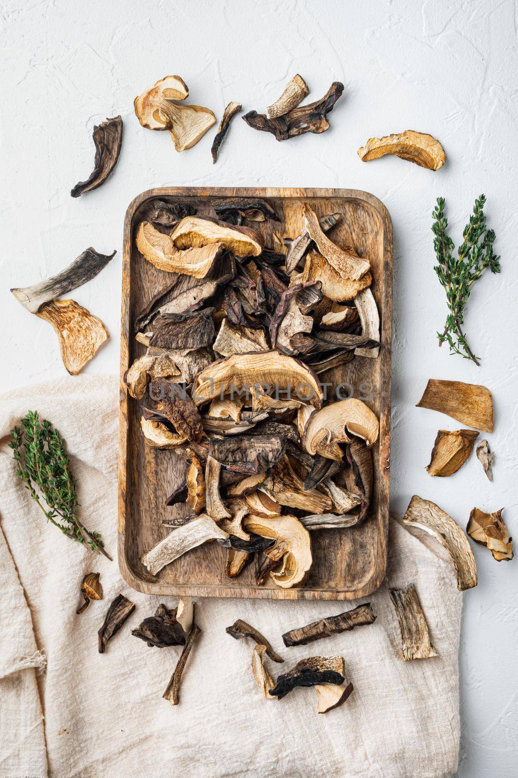 Mix of chopped wild dried mushrooms set, on white background, top view flat lay