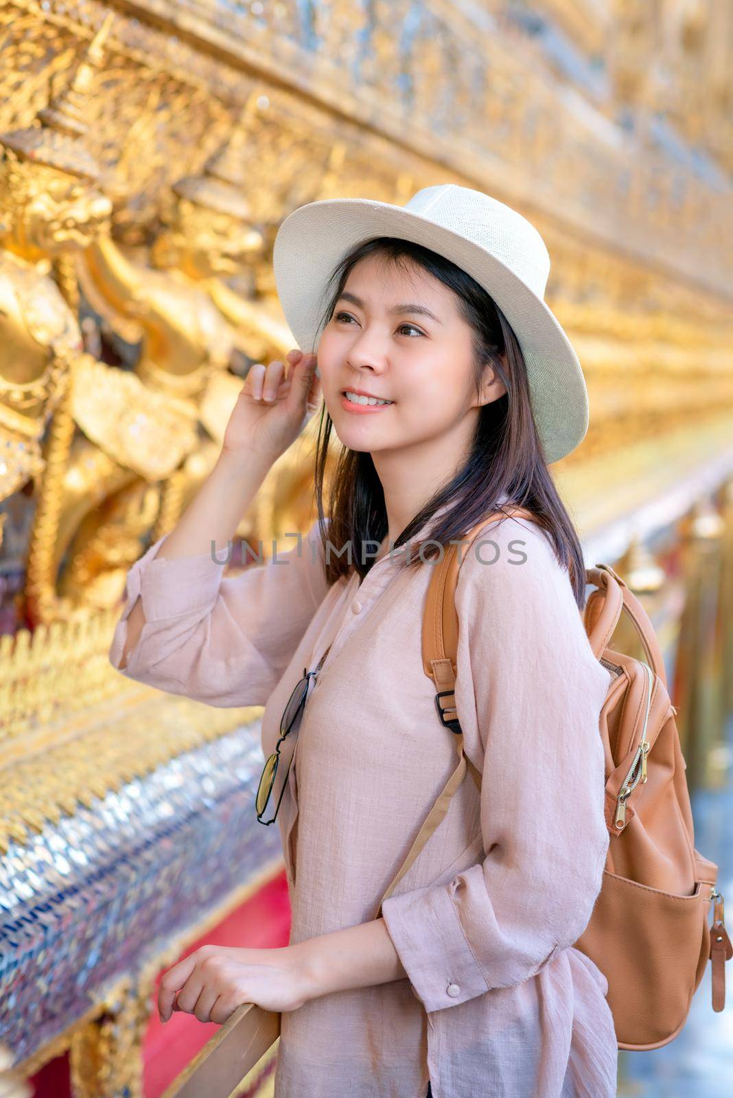 Beautiful asian tourist woman smile and enjoy travel on Vacation in Bangkok at Thailand by Nuamfolio
