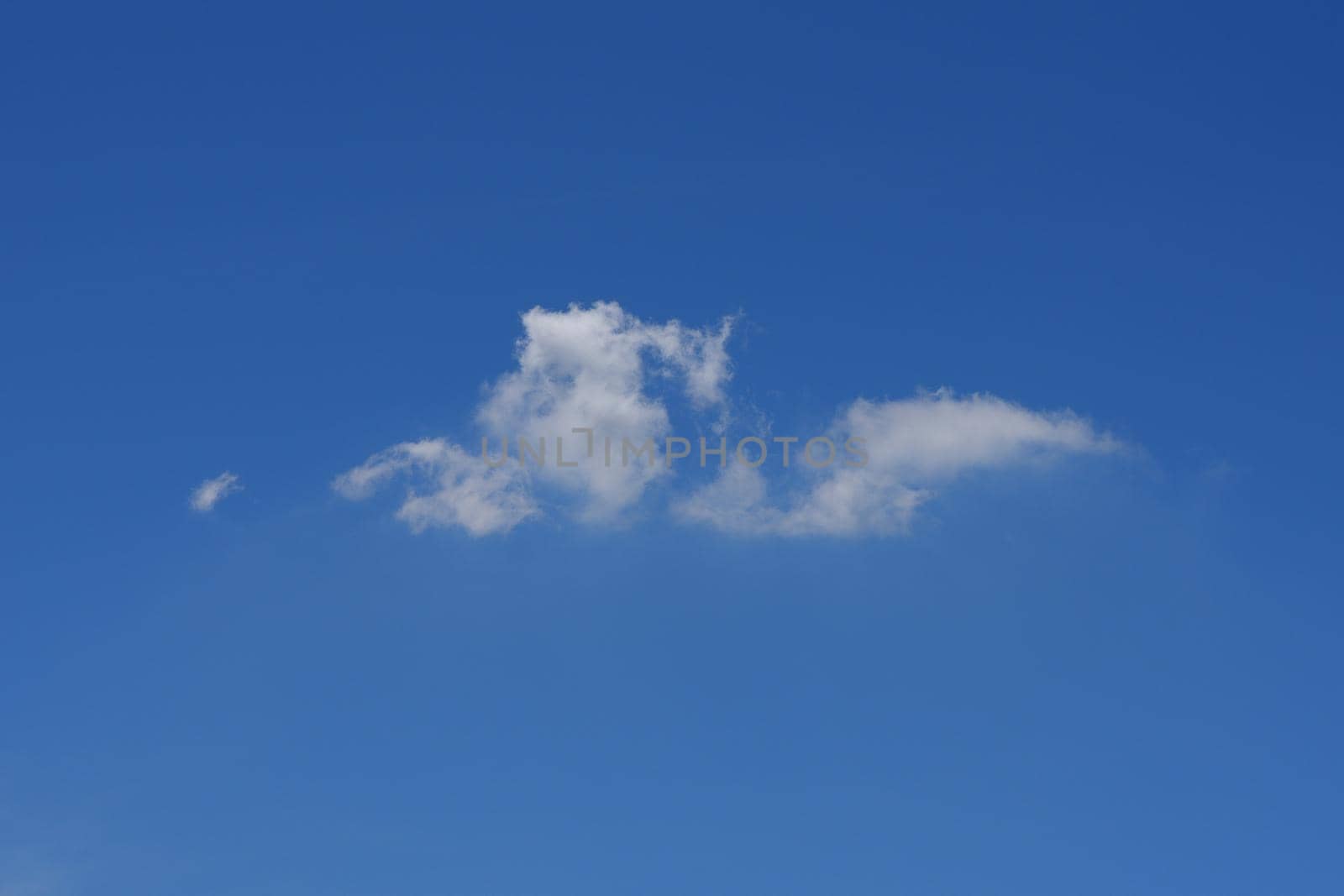 Beautiful cloudscape of nature single white cloud only one on blue sky background in daytime by Nuamfolio