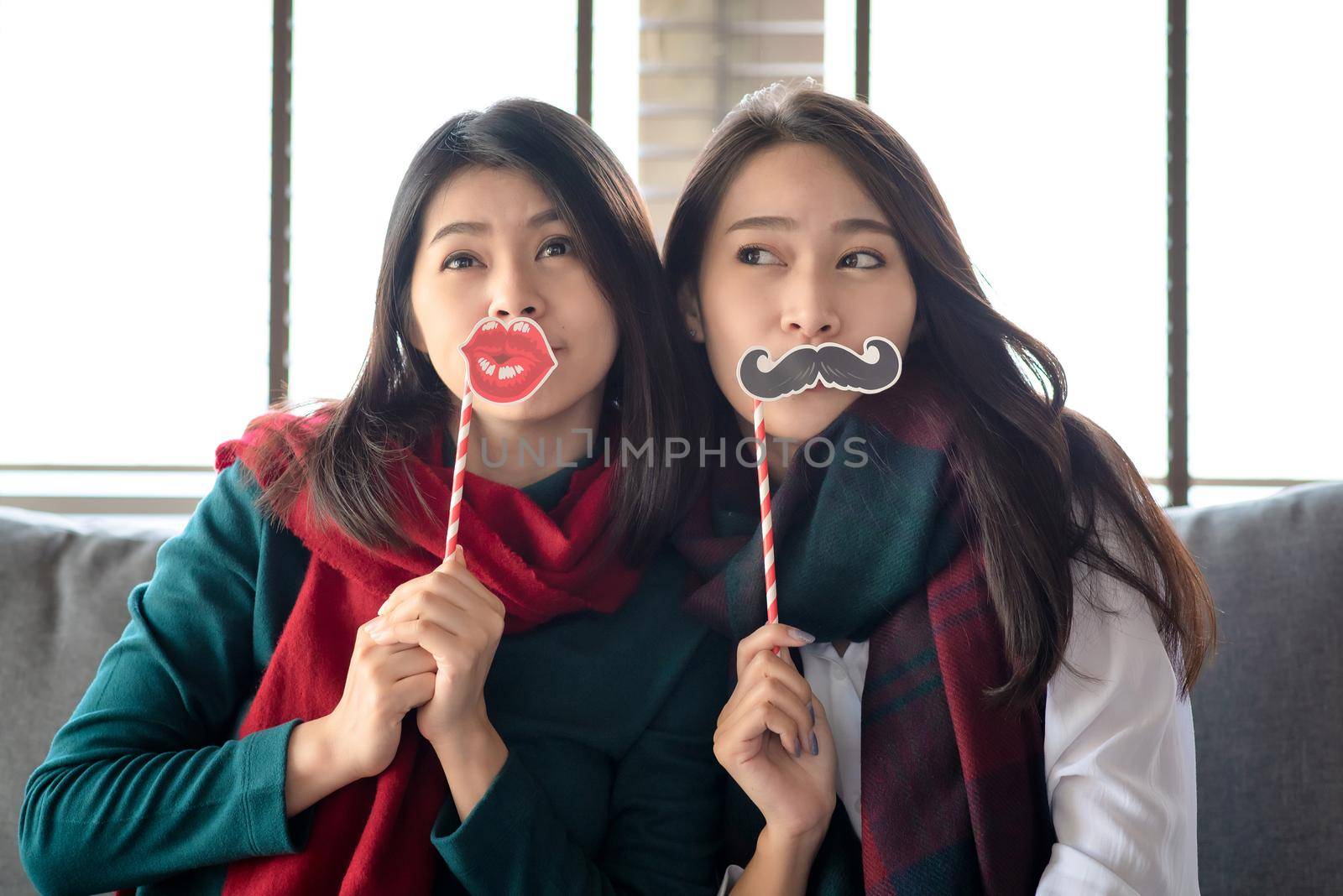Two Females enjoy to celebrate Christmas and new year party at home in December by Nuamfolio
