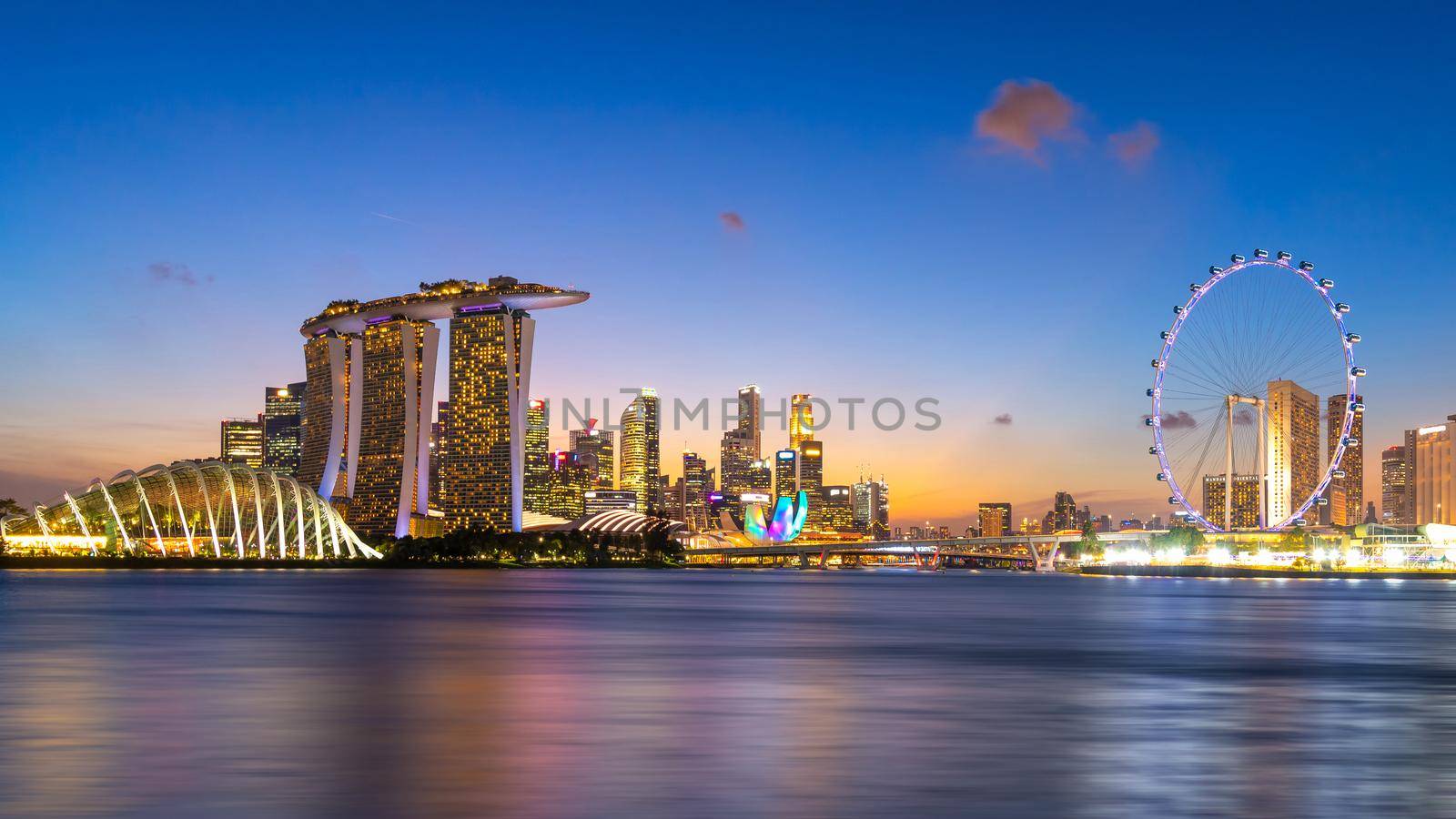 Panorama view of business downtown building area during twilight time at Singapore. by Nuamfolio