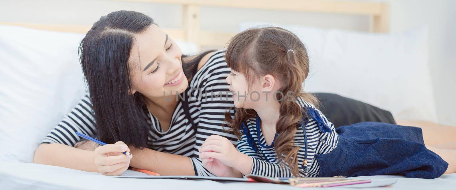 Funny mom and lovely child having fun together.Photo design for family, children and happy people concept.