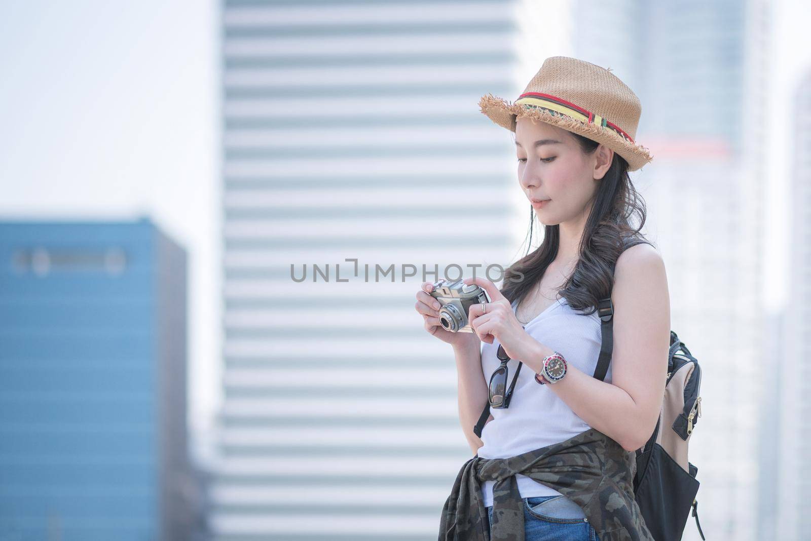Beautiful asian tourist woman enjoy taking photo by retro camera at tourist sightseeing spot by Nuamfolio