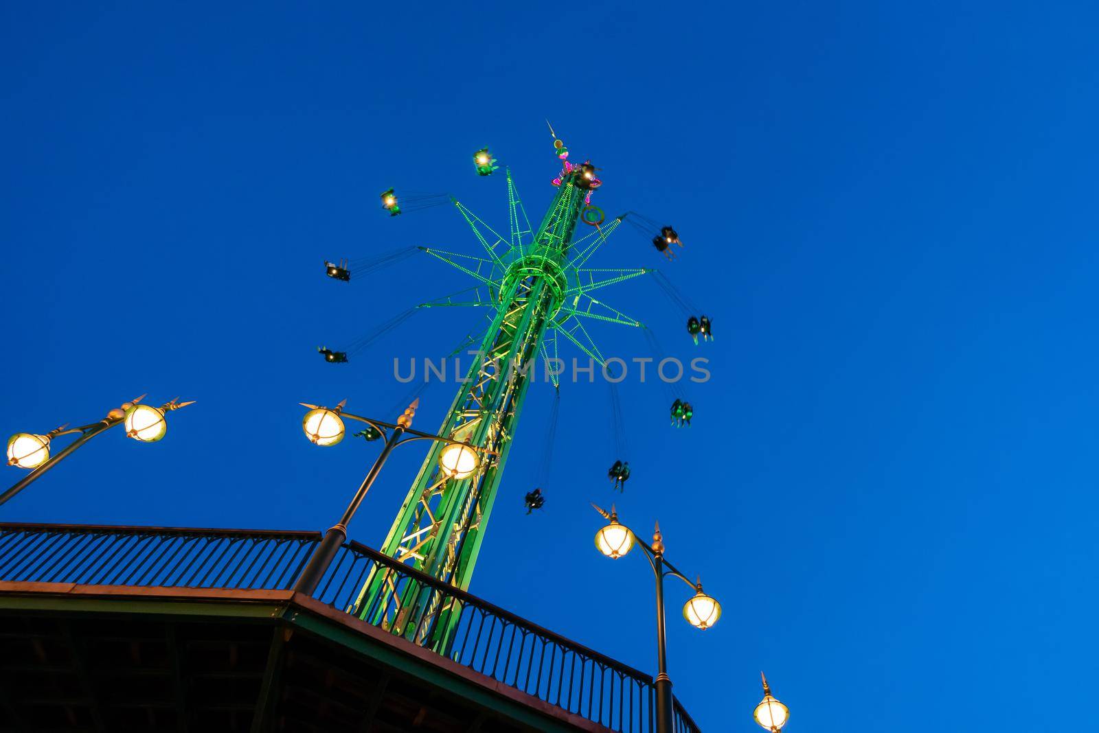 The swing ride or chair swing ride in the Tivoli amusement park at night at Copenhagen Denmark by Nuamfolio