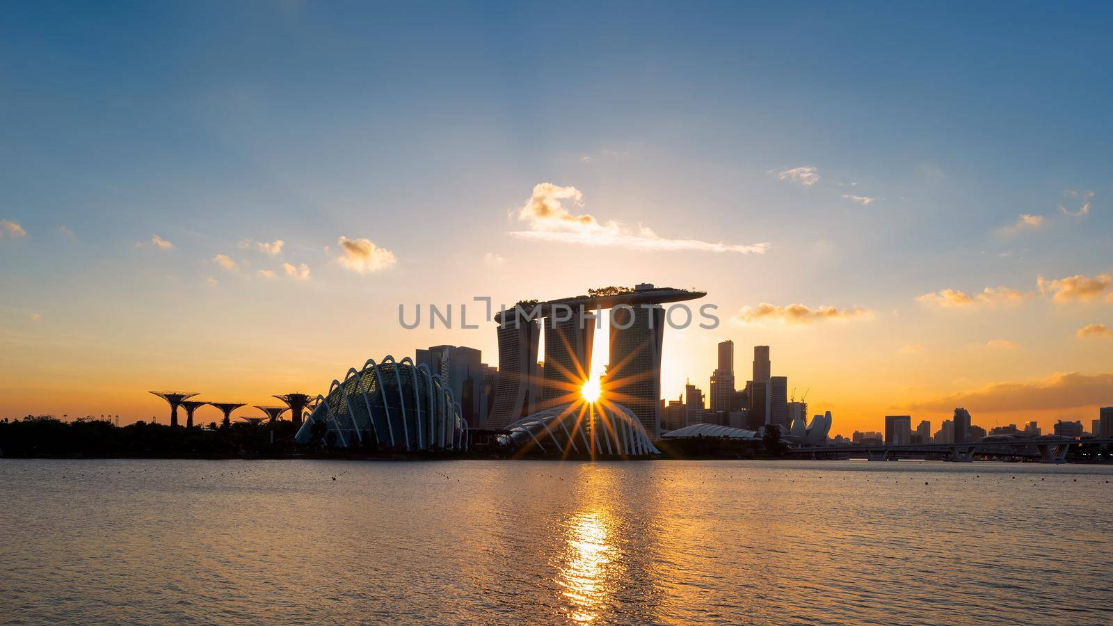 Singapore city view of business downtown building area from marina barrage during sunset at Singapore. by Nuamfolio