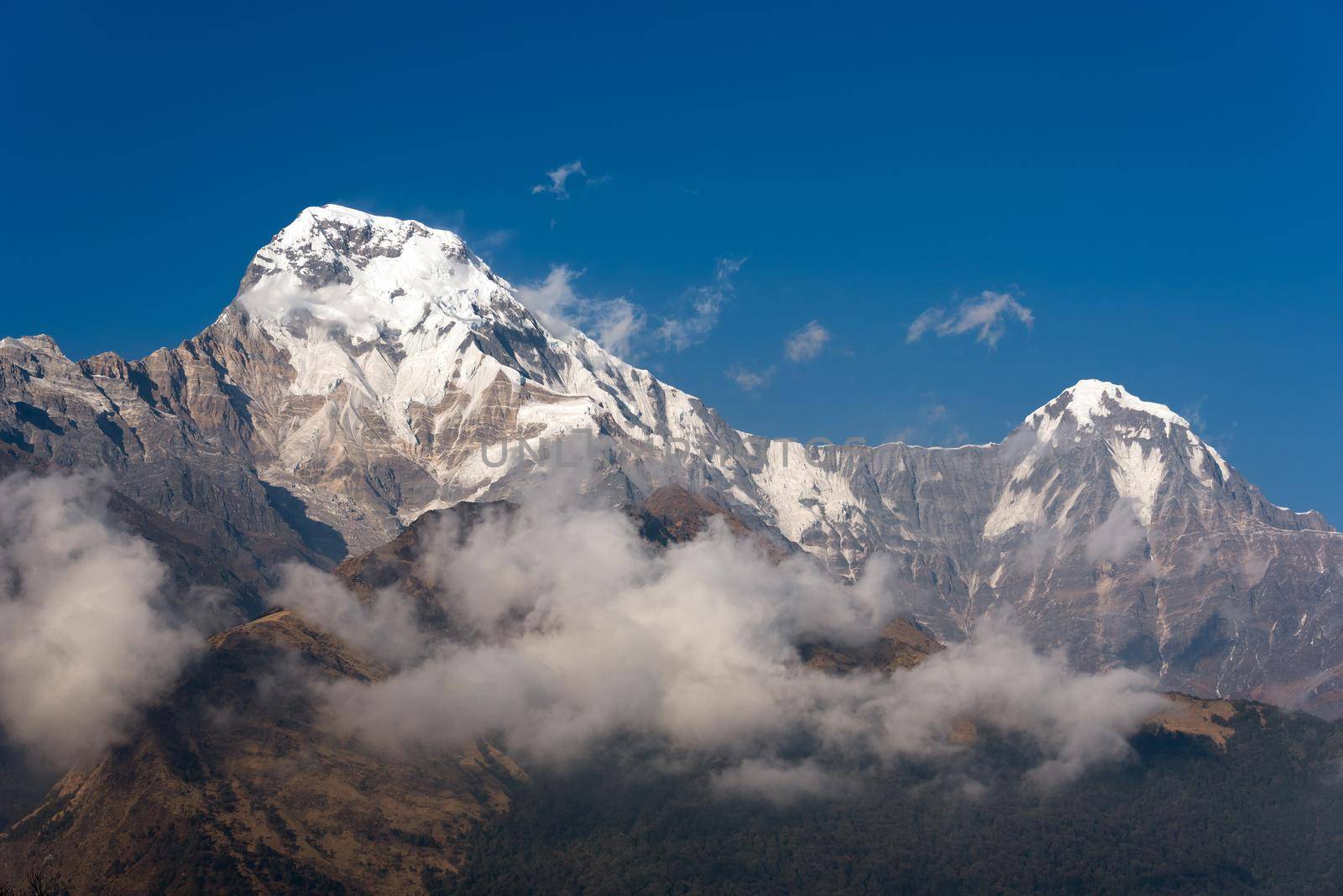 Annapurna South mountain peak with blue sky background in Nepal by Nuamfolio