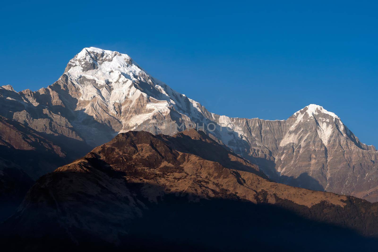 Annapurna South mountain peak with blue sky background in Nepal by Nuamfolio