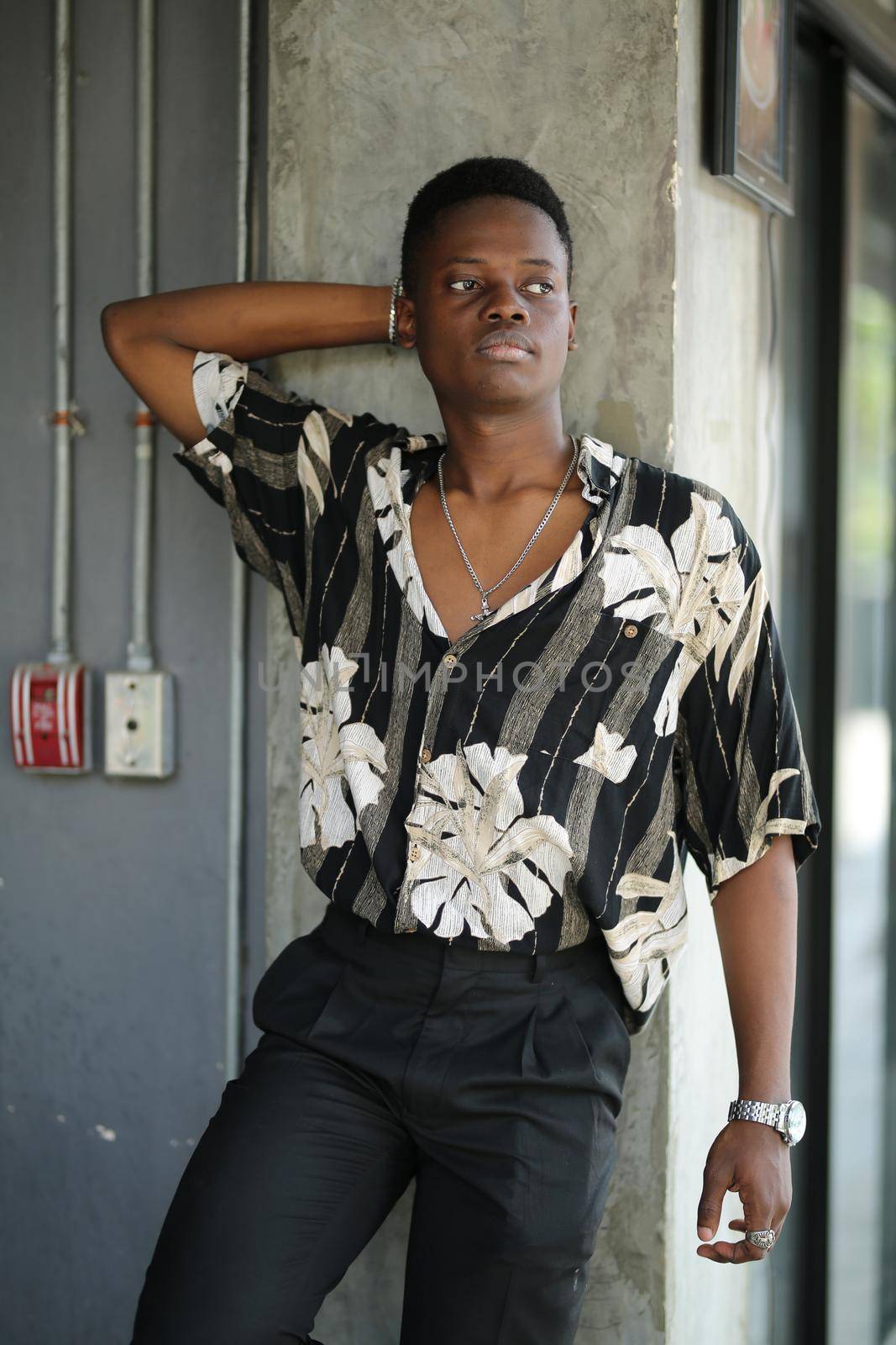 Portrait of young handsome afro black man posing outdoor.