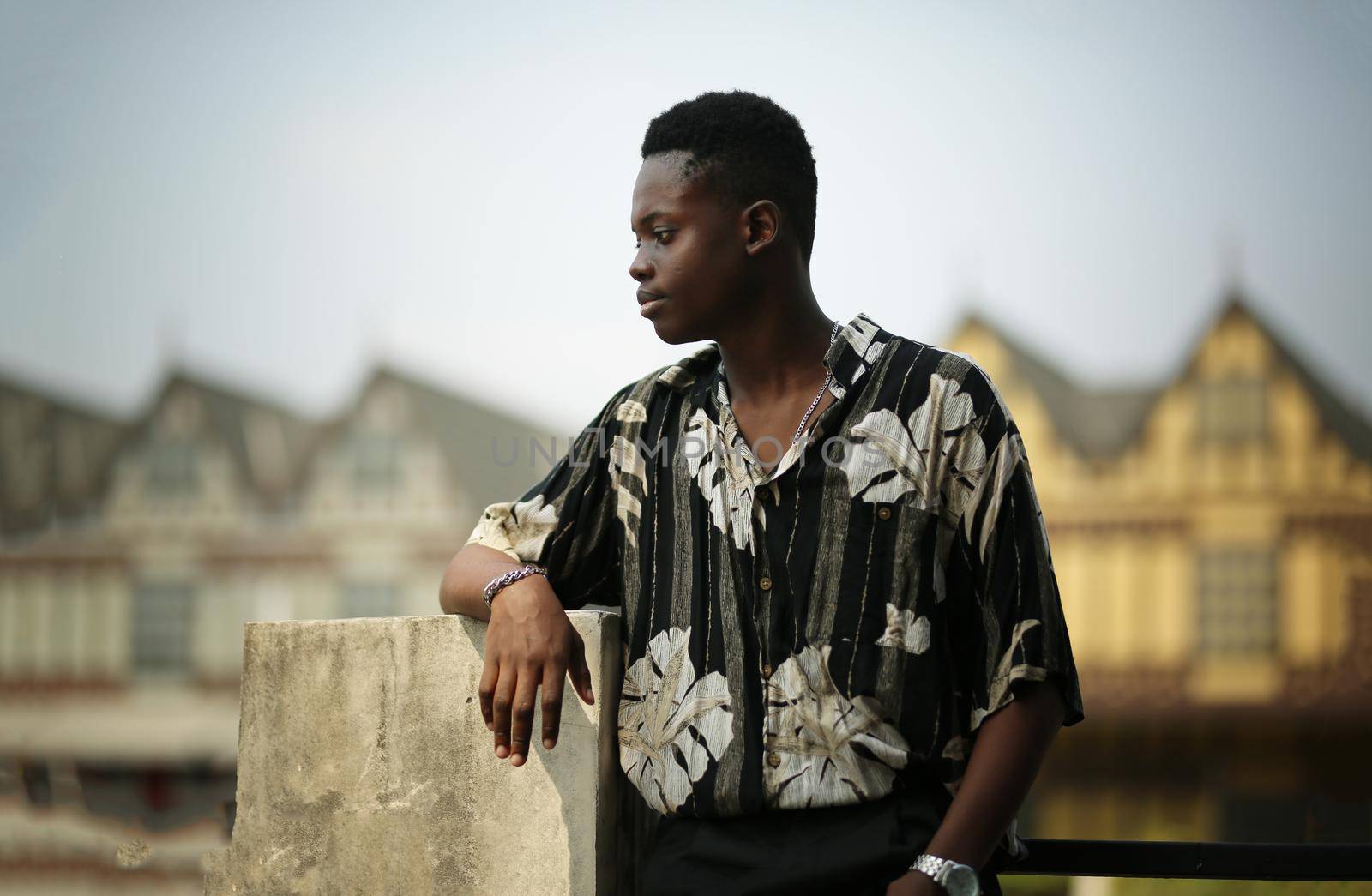 Portrait of young handsome afro black man posing outdoor.