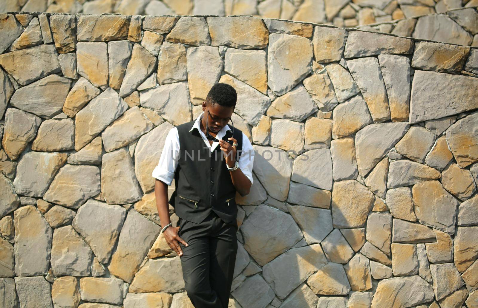 Portrait of young handsome afro black man posing outdoor.